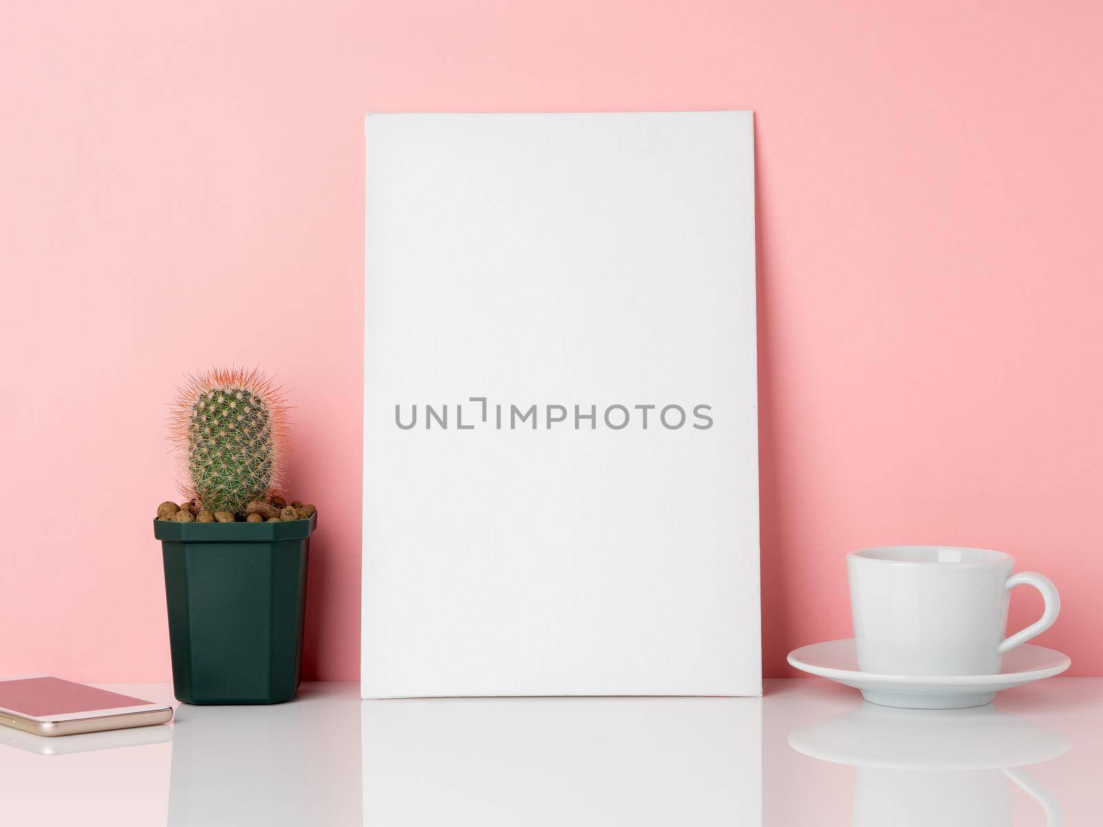 Blank white frame and plant cactus, cup of coffee or tea on a white table against the pink wall with copy space. Mockup with copy space. by NataBene