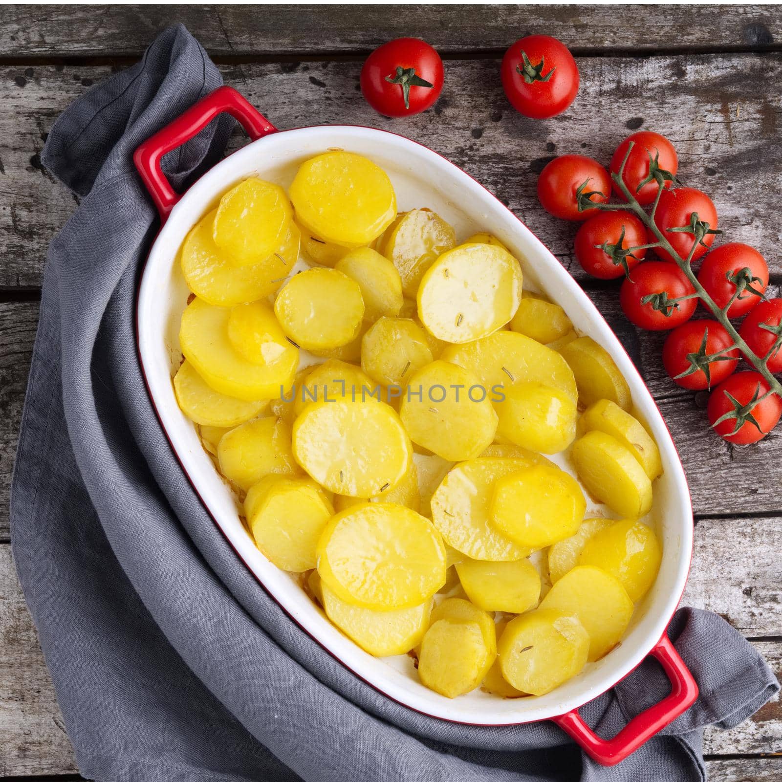 Baked slice of potatos, a healthy diet food. Dark old wooden rustic gray background, top view