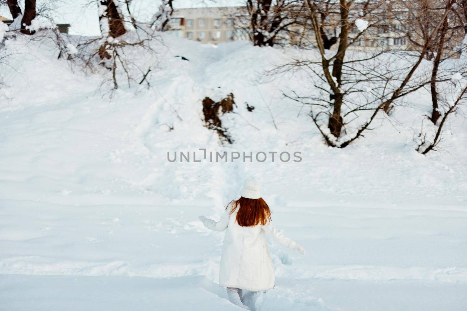 pretty woman in a white coat in a hat winter landscape walk Lifestyle. High quality photo