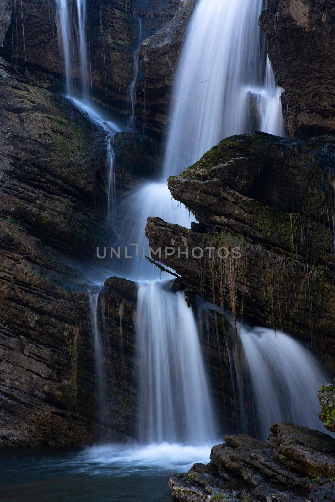 Beautiful waterfall cascading down cliff and boulders in Australian high country by lovleah