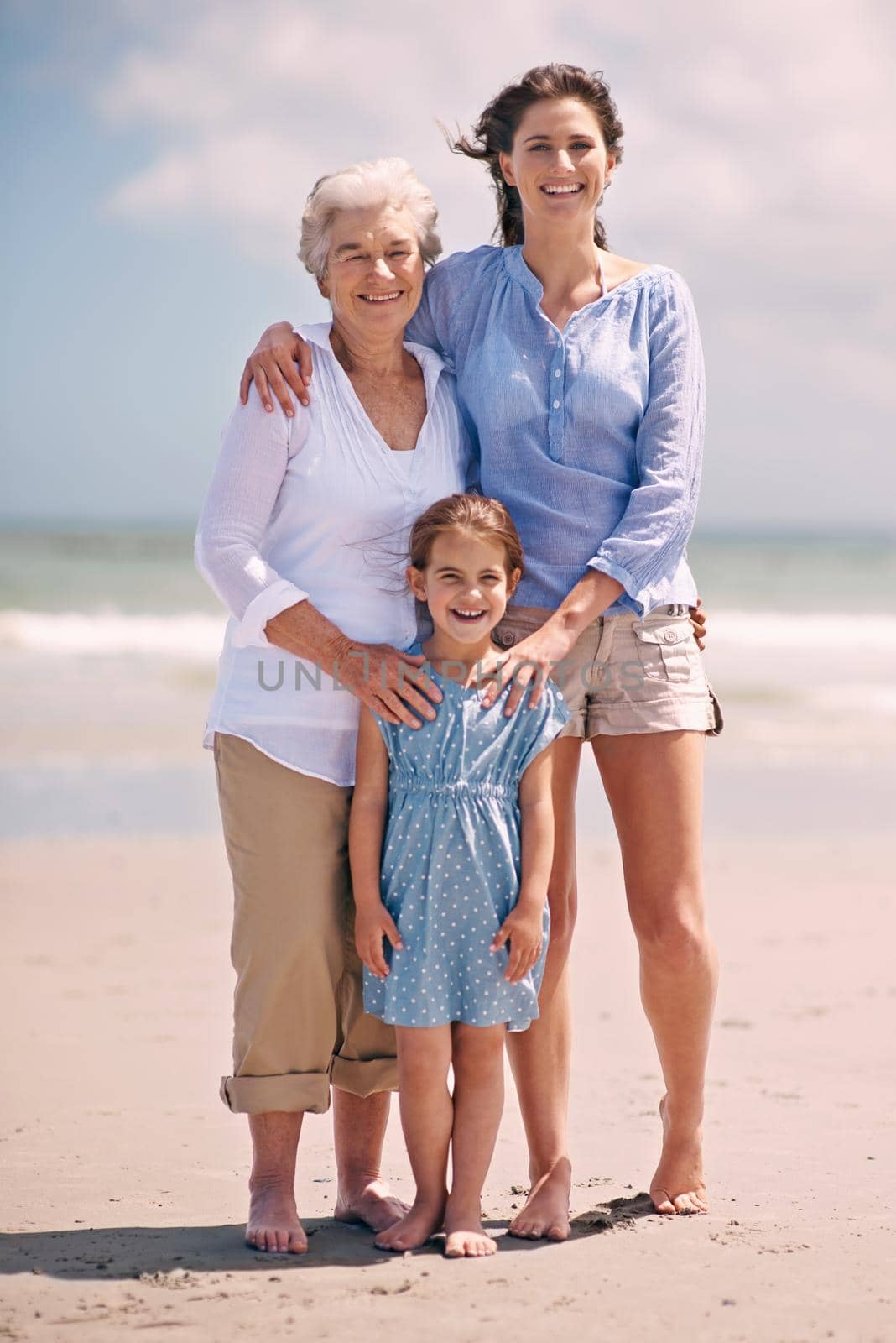 The ladies in my life. Portrait of a woman with her daughter and mother at the beach. by YuriArcurs