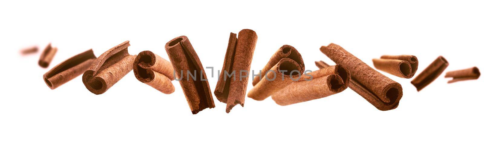 Cinnamon sticks levitate on a white background.