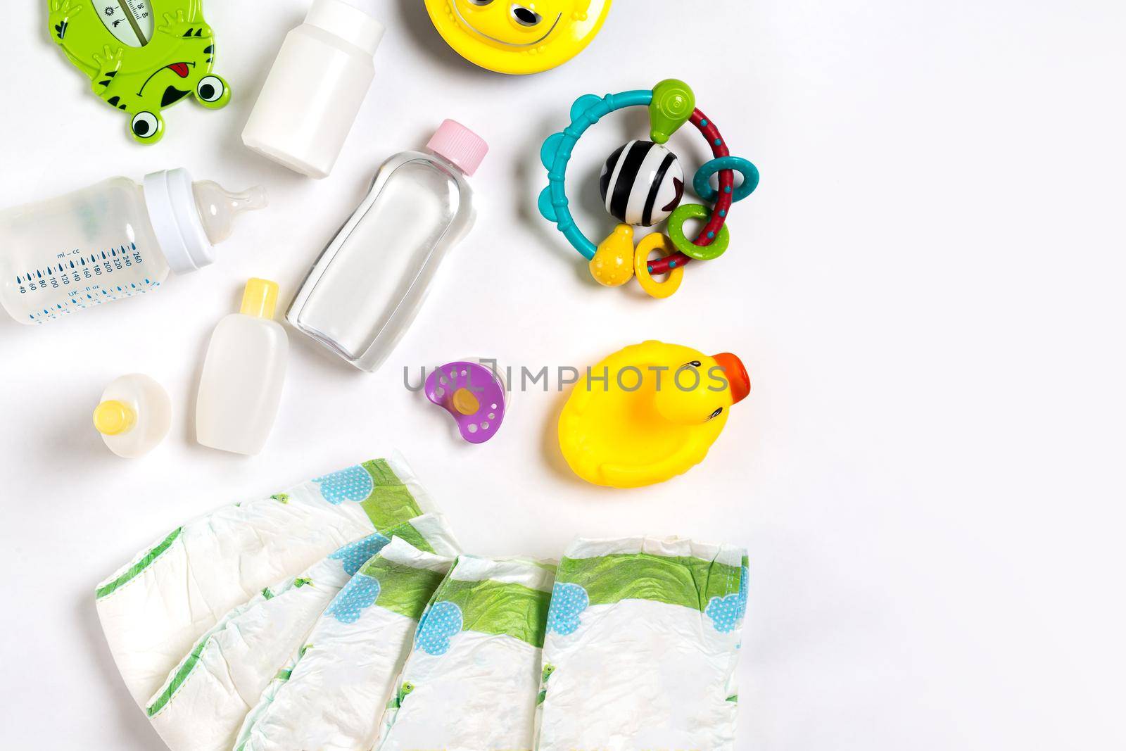 Babies goods diaper, baby powder, cream, shampoo, oil on white background with copy space. Top view or flat lay. by nazarovsergey