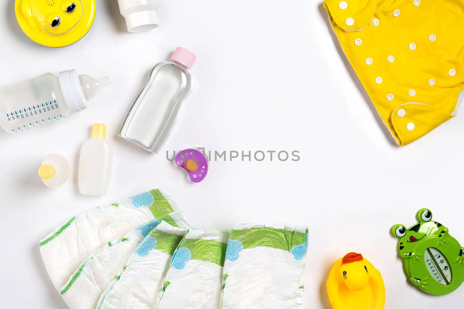 Babies goods diaper, baby powder, cream, shampoo, oil on white background with copy space. Top view or flat lay. by nazarovsergey