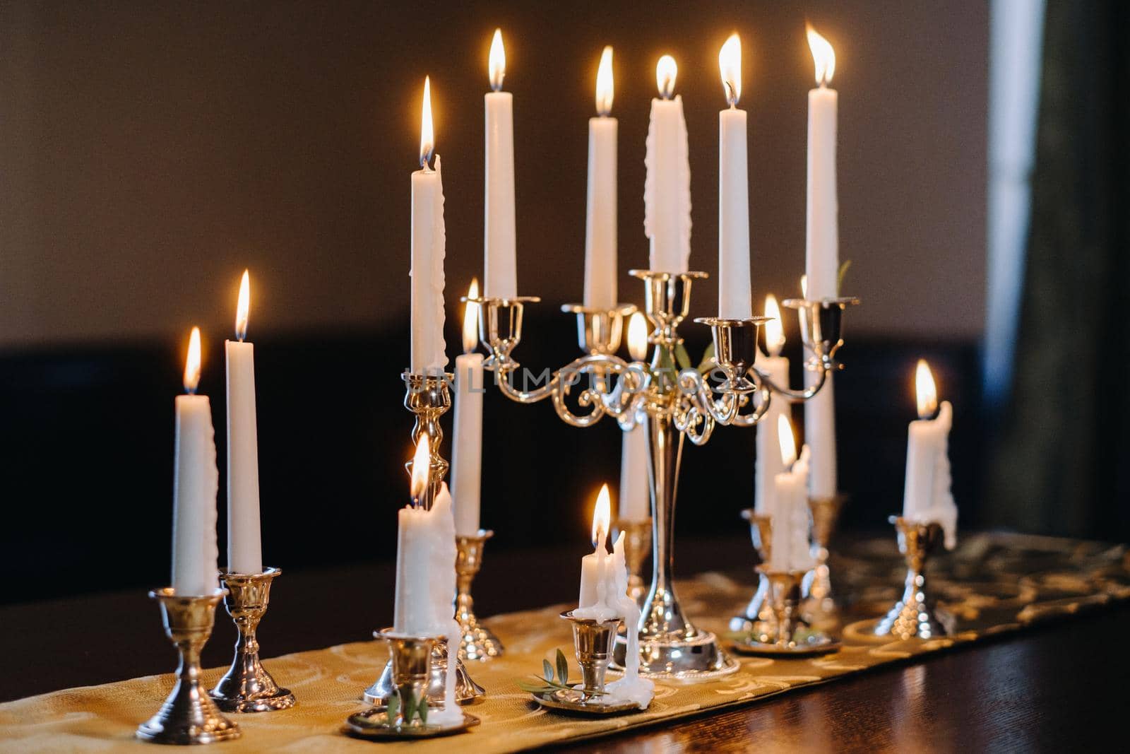 Burning candles standing on the table. Candlelit Party.