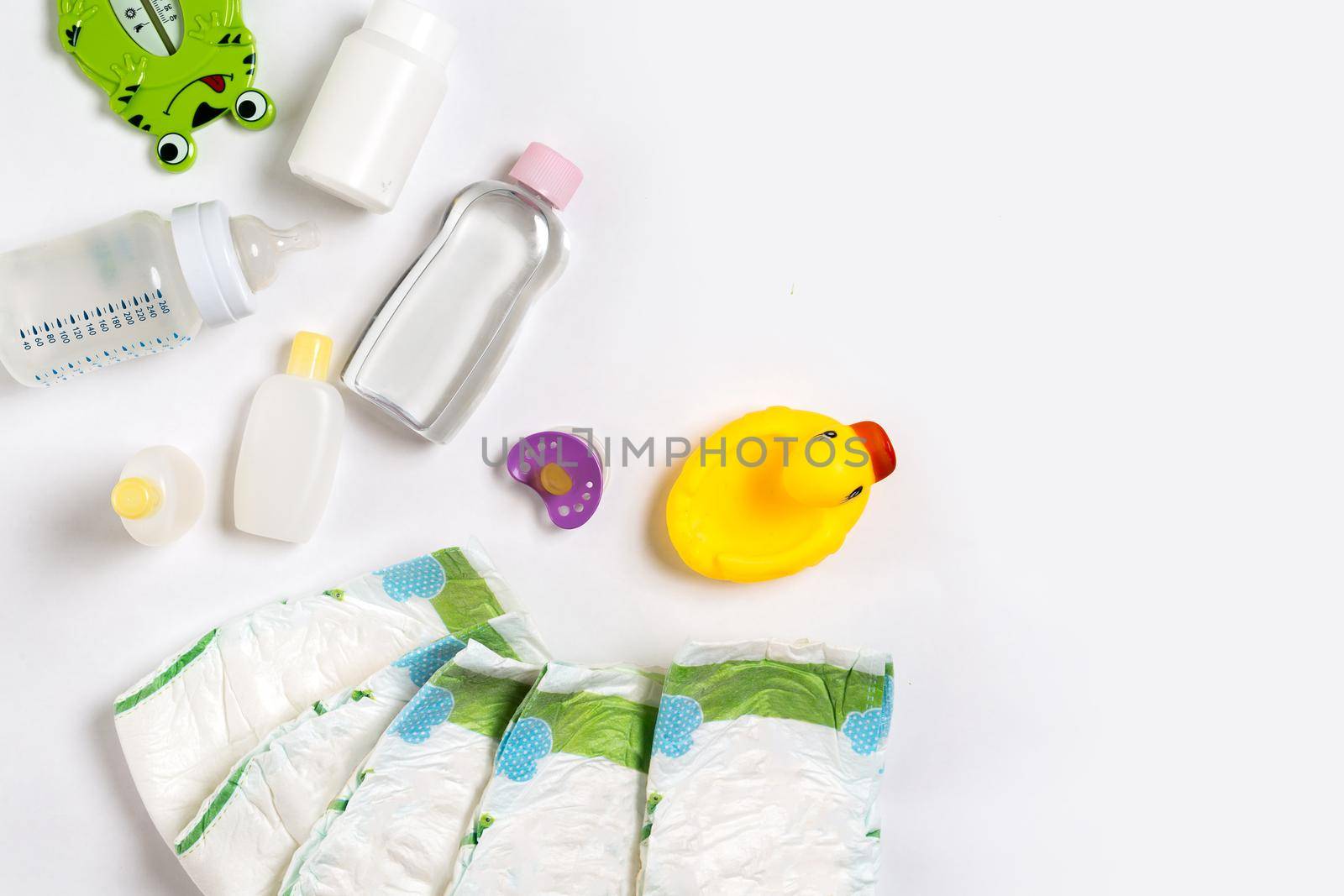 Babies goods diaper, baby powder, cream, shampoo, oil on white background with copy space. Top view or flat lay. by nazarovsergey