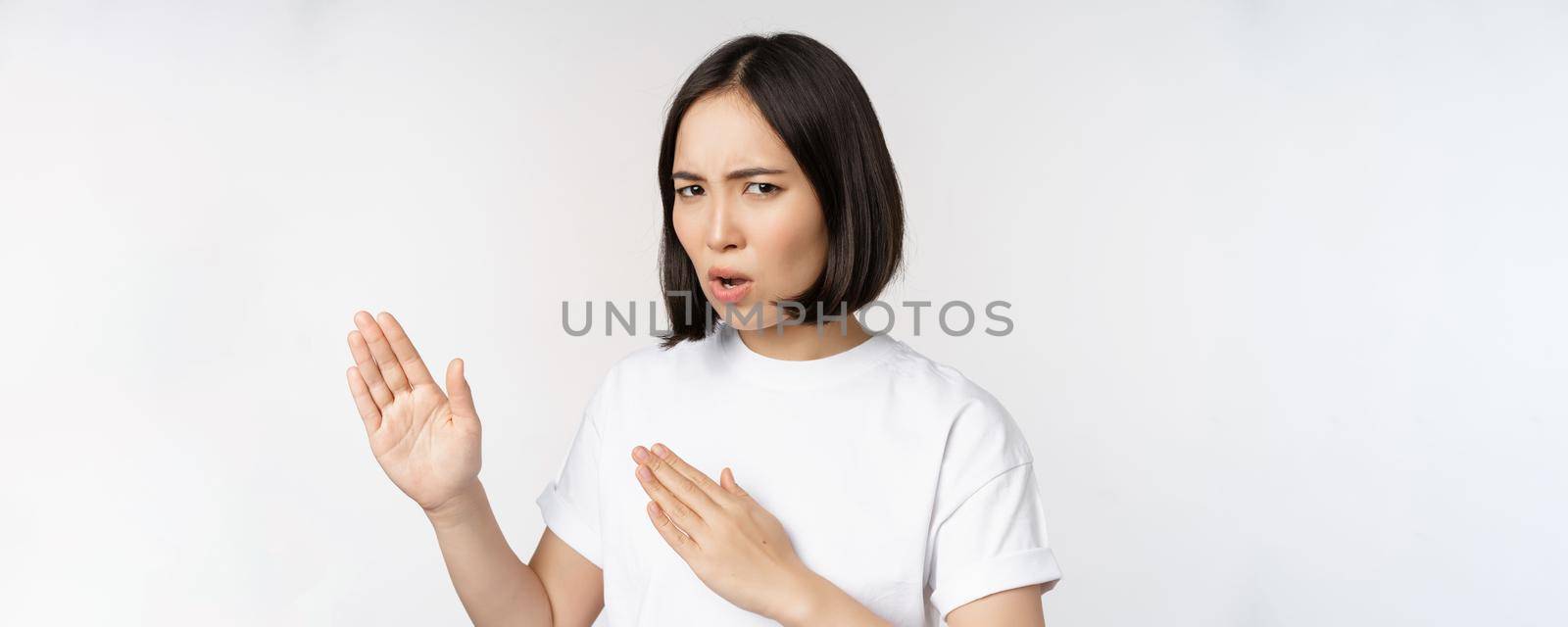Image of sassy young asian woman standing in karate fighting pose, martial arts fighter, standing over white background.