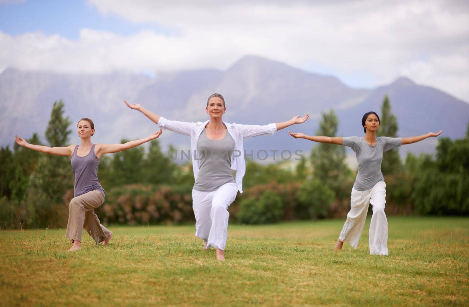 Peace in nature. Women doing yoga outdoors. by YuriArcurs