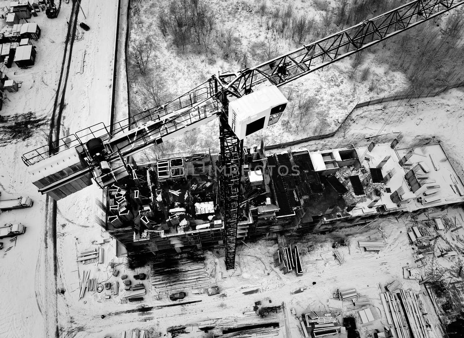 Construction Crane from Above. tower crane on the construction site aerial view. Aerial View Of construction site with crane. Construction workers are building. Top view.