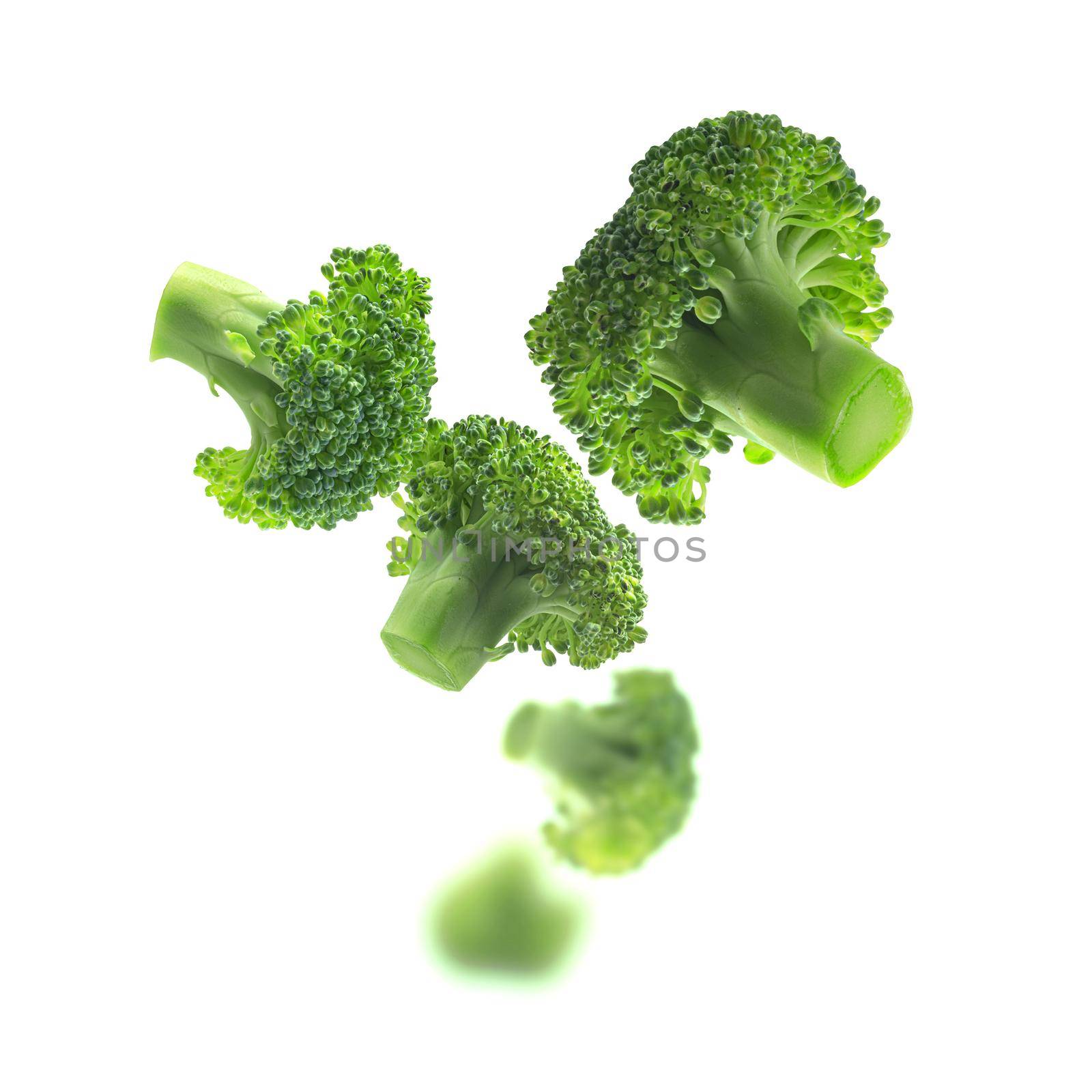 Green broccoli levitating on a white background.
