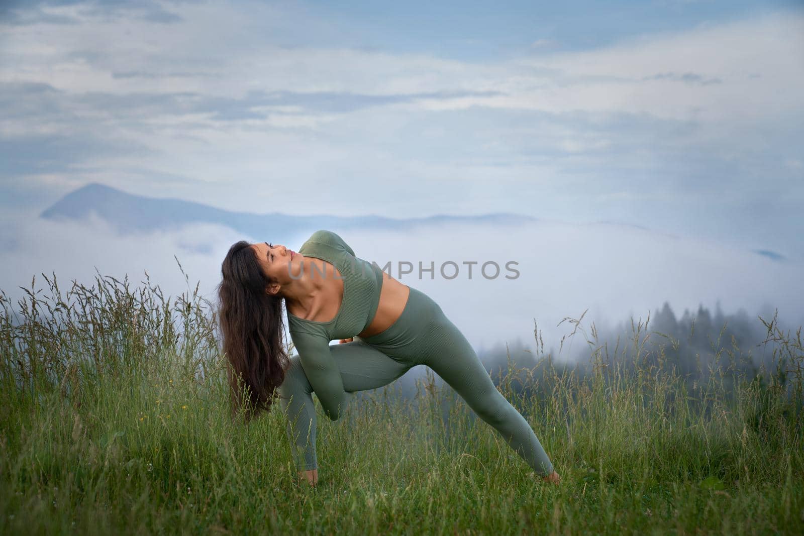 Athletic woman practising yoga with view on mountains by SerhiiBobyk