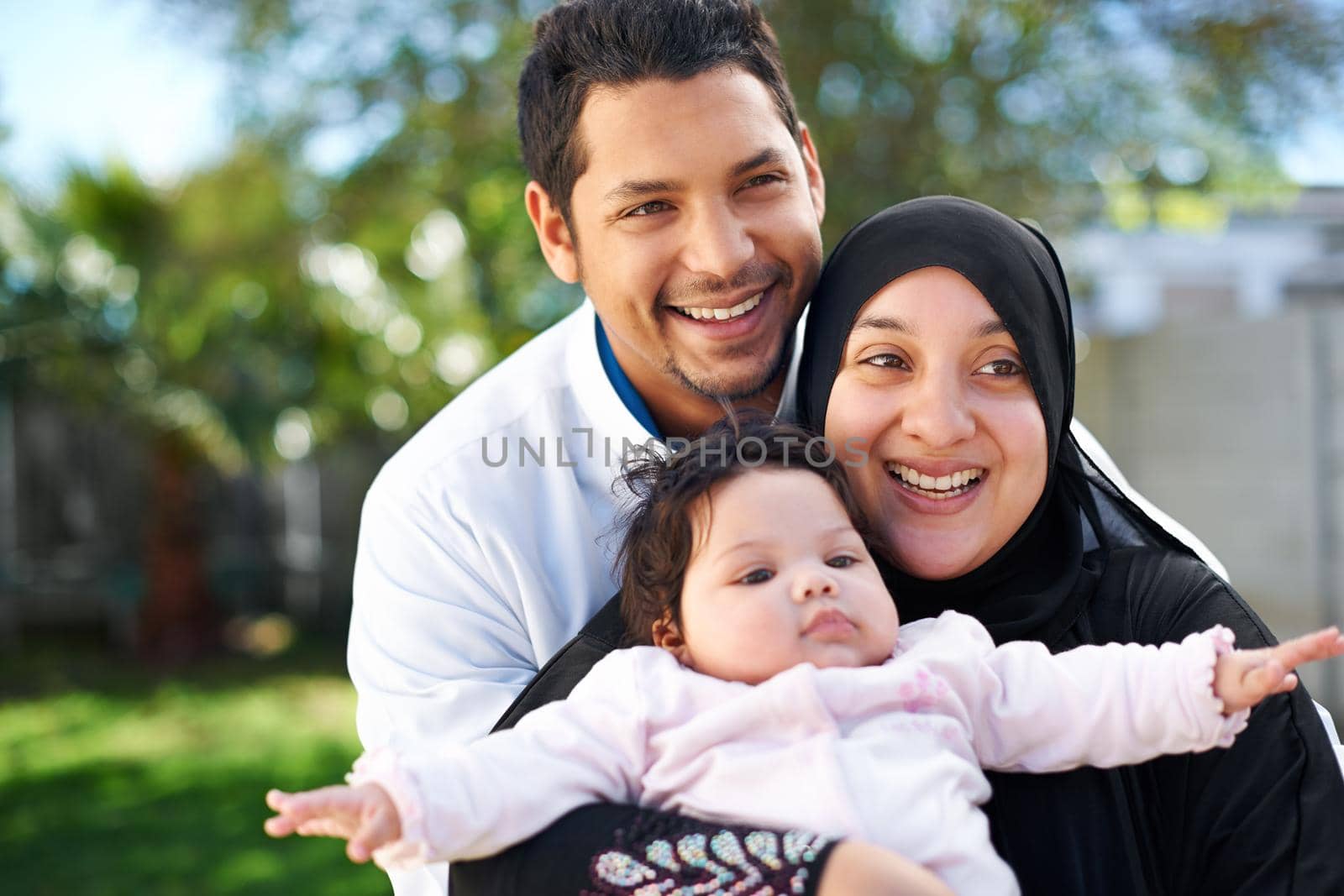 Were a blessed family. Portrait of a muslim family enjoying a day outside. by YuriArcurs