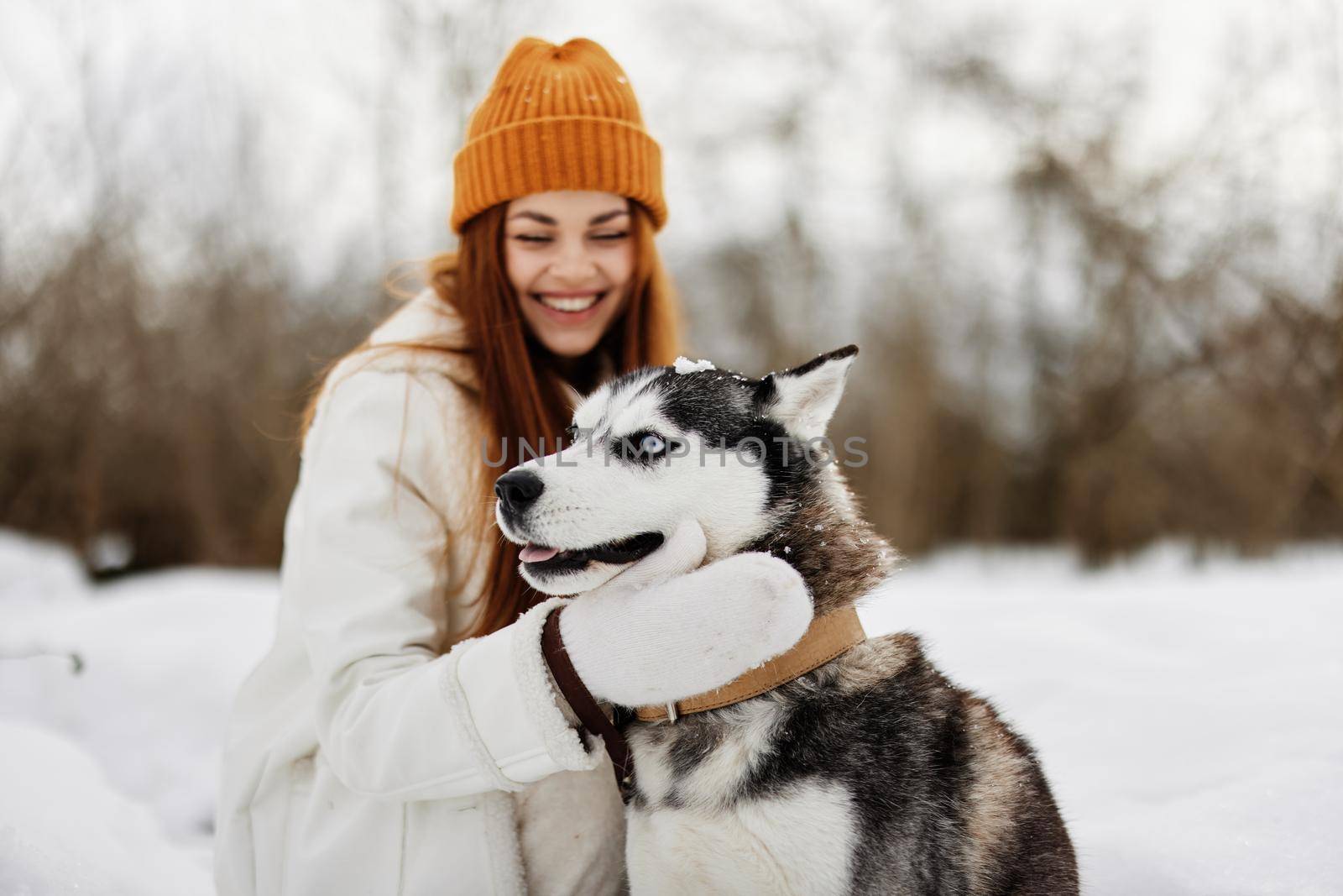 young woman with husky on the snow walk play rest fresh air. High quality photo