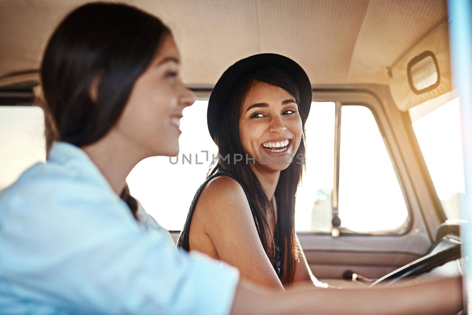 Road trips are always a good idea. Shot of two happy young friends going on a road trip. by YuriArcurs