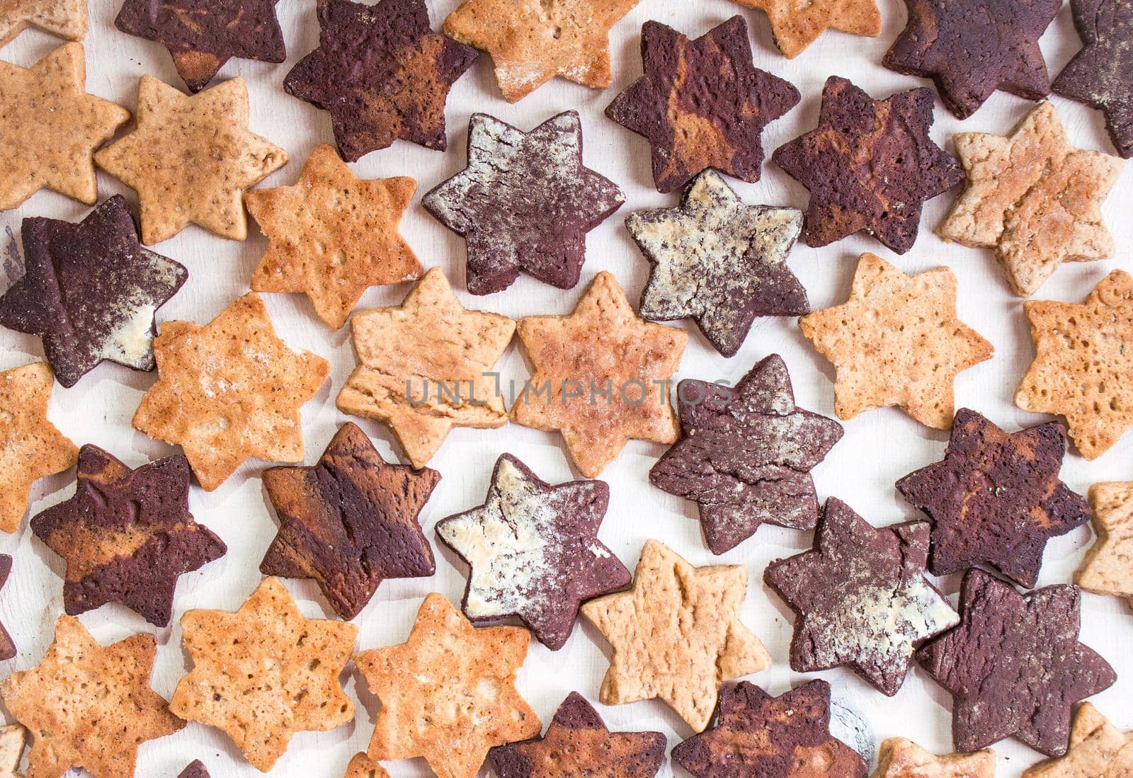 Assorted christmas ginger cookies over white wooden table. Christmas cooking background. Six pointed star cookies