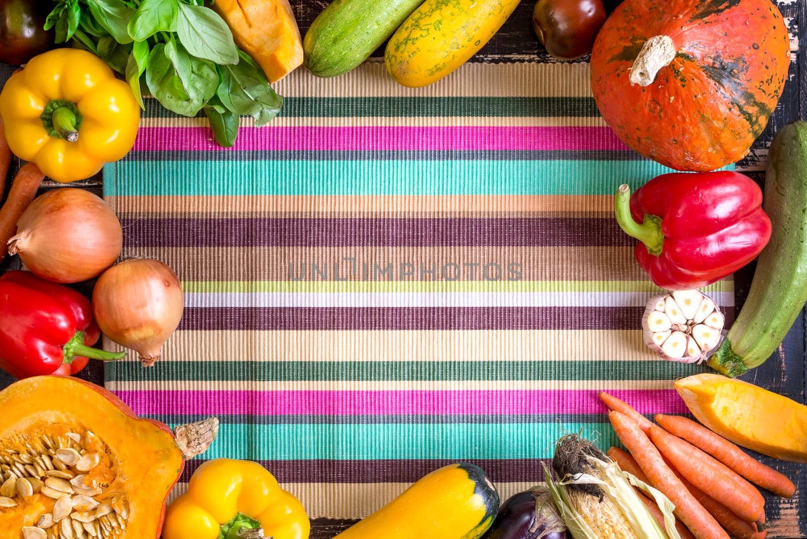 Fresh vegetables on a colorful striped kitchen towel. Autumn background by its_al_dente