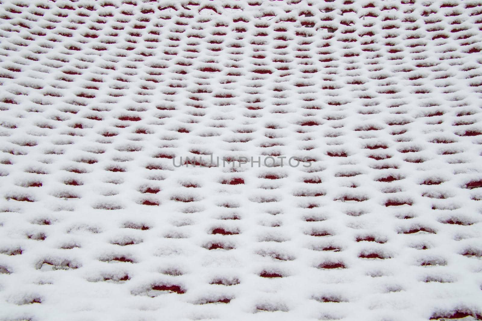 White and red background, snow on the hammock, snow pattern and texture