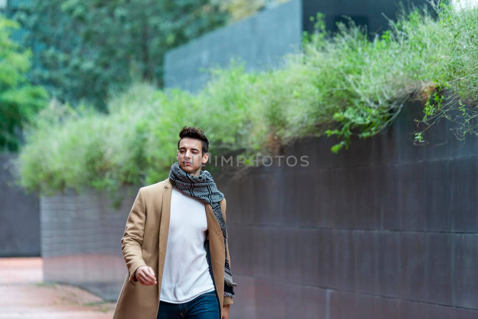 Handsome young man wearing winter clothes walking on the city by raferto1973