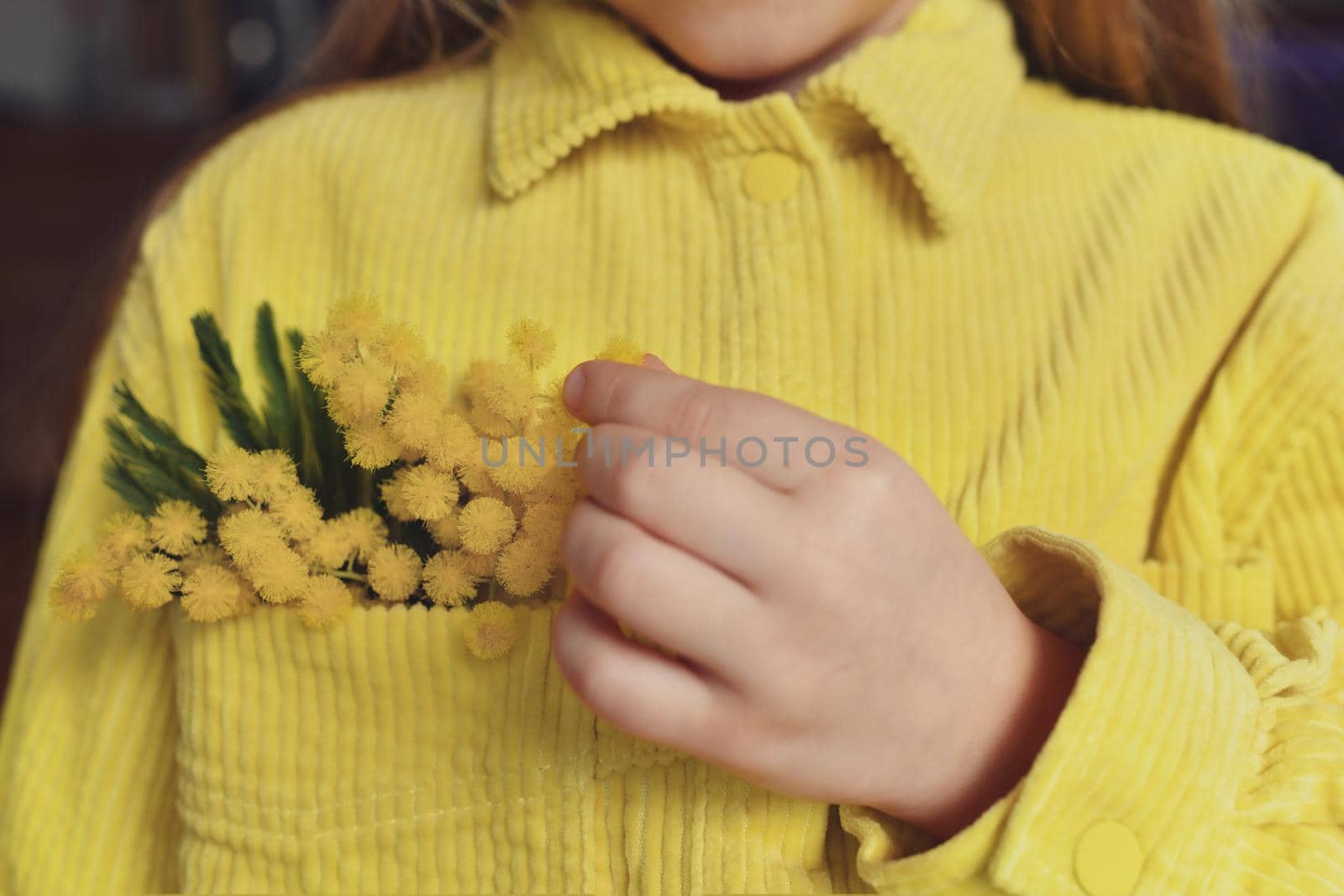 A girl holding mimosa in the pocket