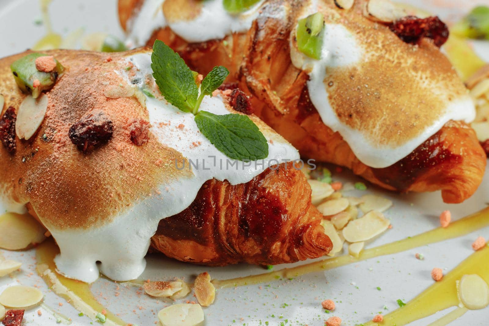 croissant with sweet cream and almonds on a plate. Delicious and healthy breakfast by UcheaD