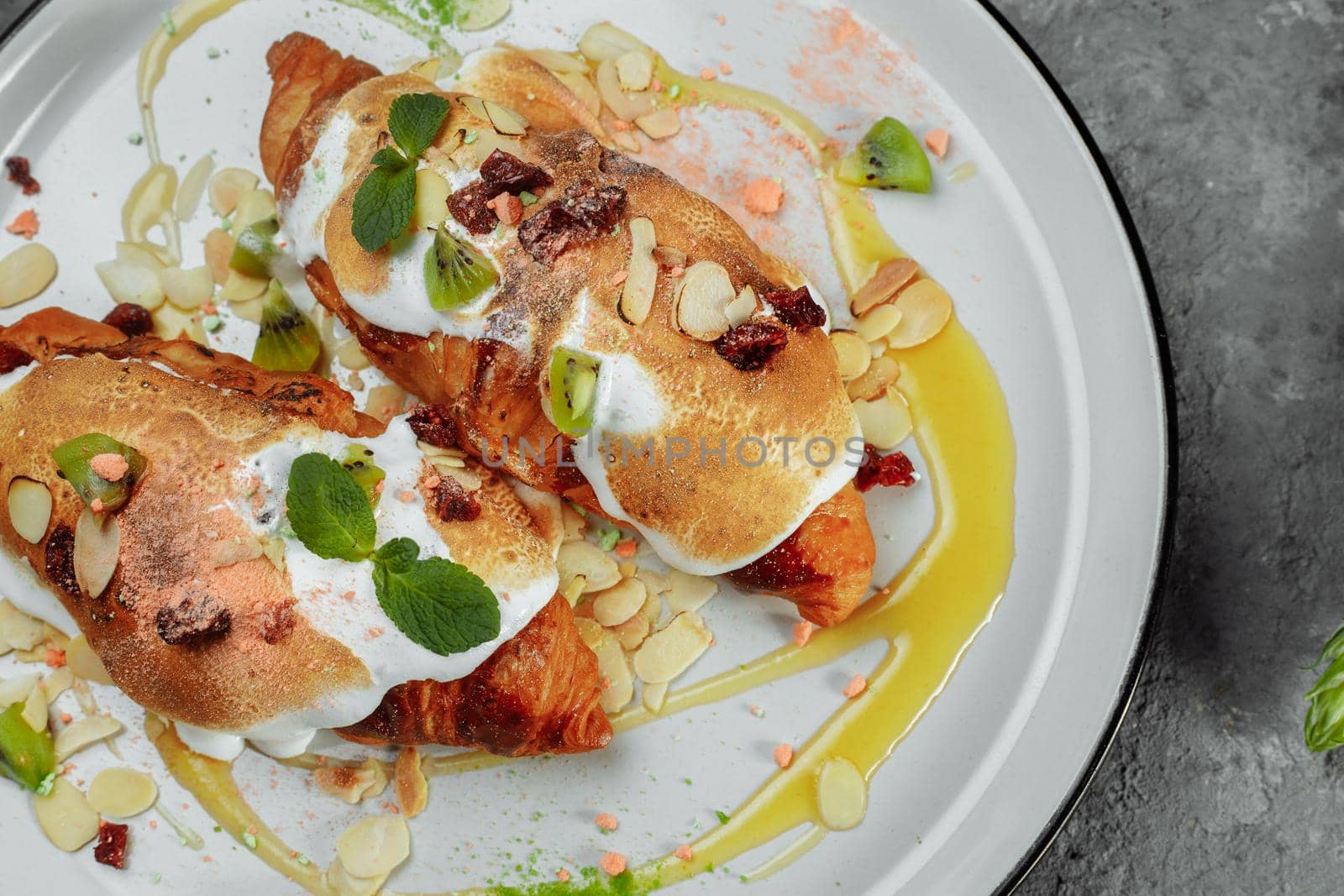 croissant with sweet cream and almonds on a plate. Delicious and healthy breakfast by UcheaD