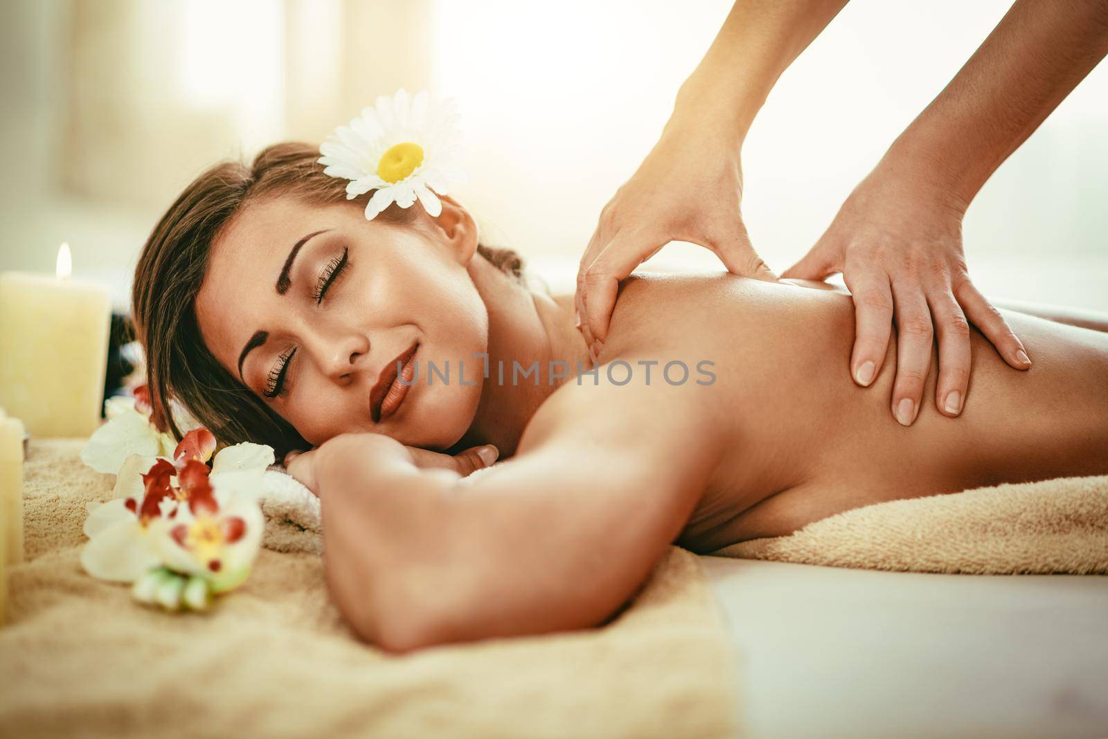 Woman enjoying during a back massage at a spa. 