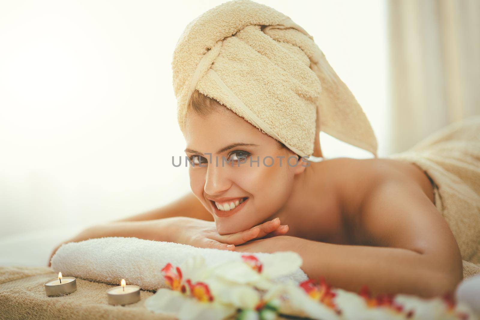 Cute young woman is enjoying during a skin care treatment at a spa. 