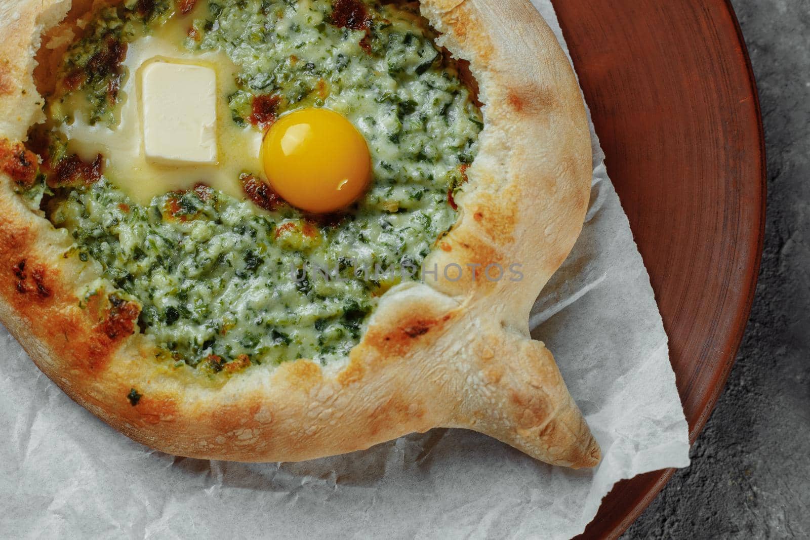 Some khachapuri traditional Georgian homemade cheese and spinach pies on the plate.