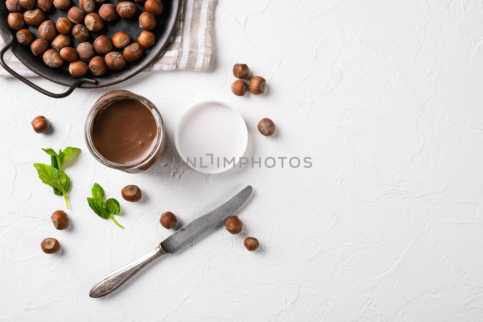 Chocolate spread jar set, on white stone table background, top view flat lay, with copy space for text