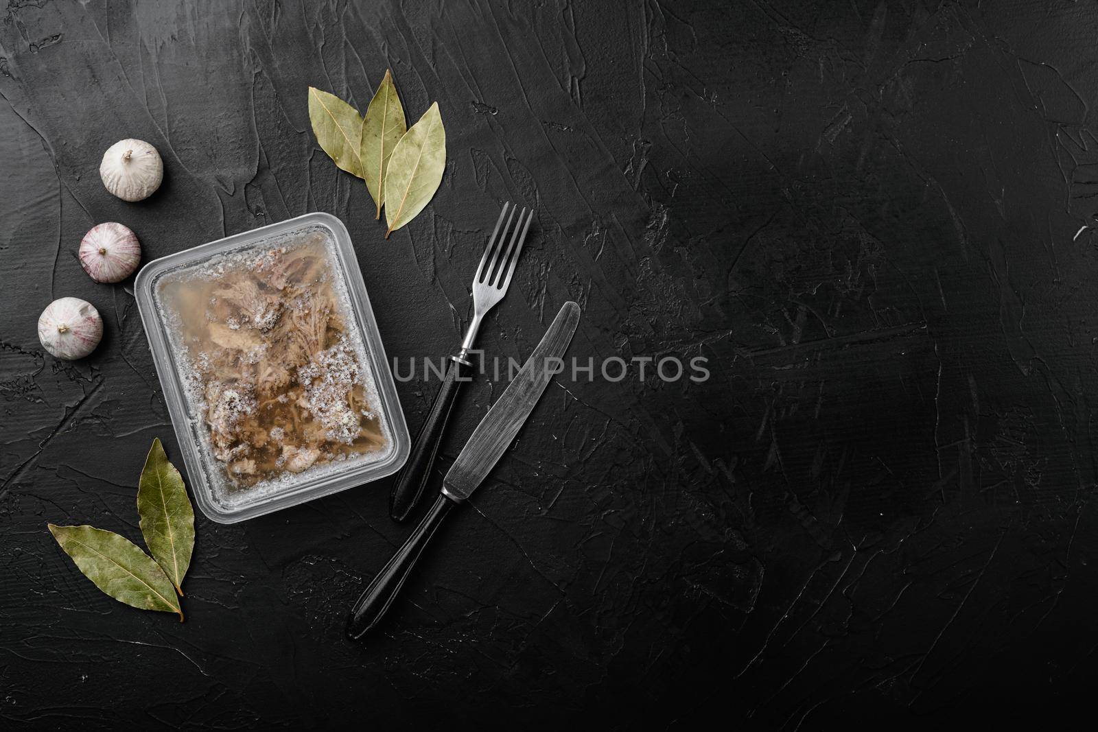 Homemade delicious jelly meat set, on black dark stone table background, top view flat lay, with copy space for text