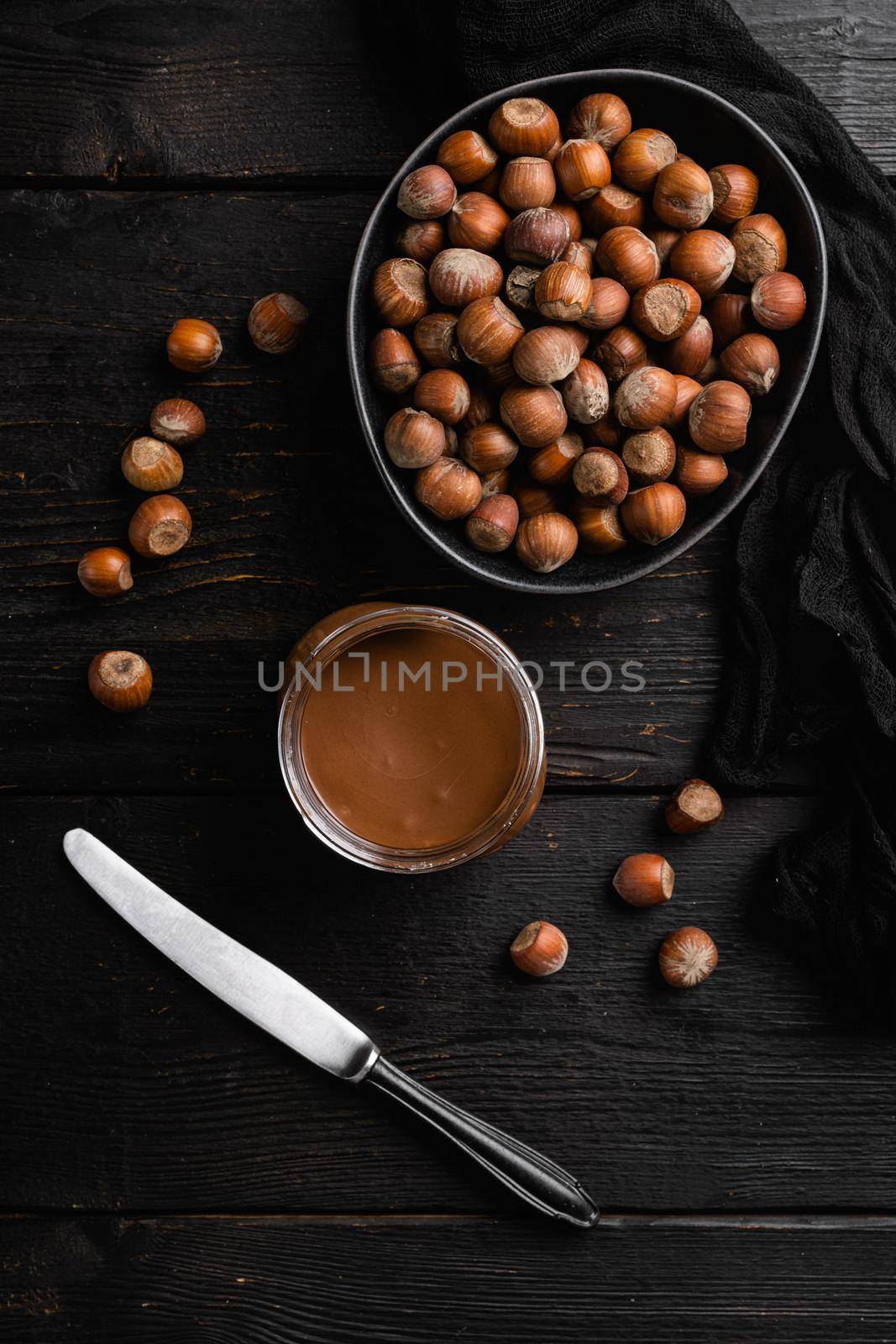 Chocolate spread jar set, on black wooden table background, top view flat lay