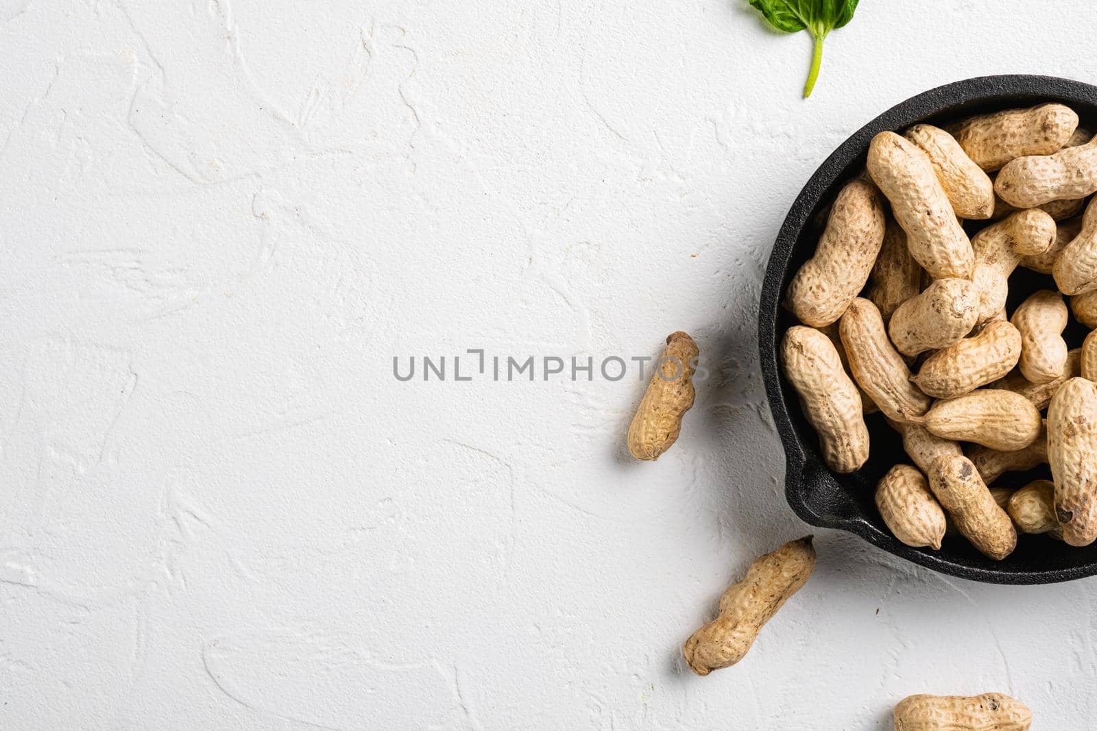 Peanuts serving to make oil, peanut butter set, on white stone table background, top view flat lay, with copy space for text