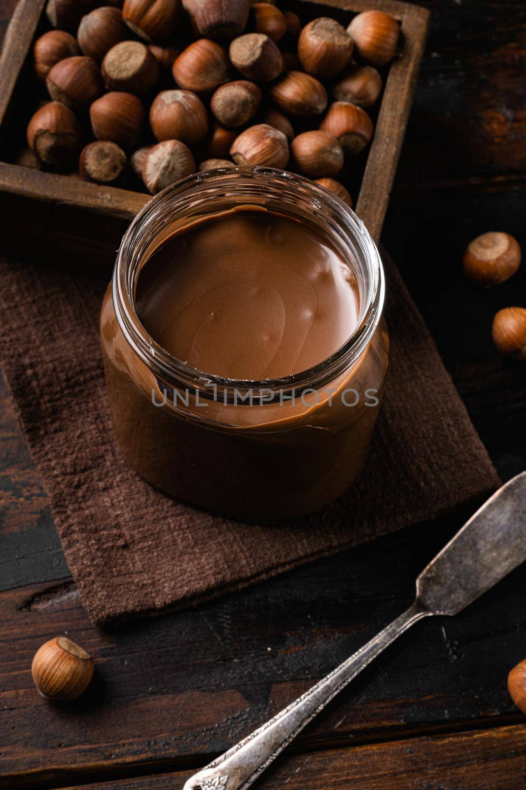 Sweet hazelnut spread, on old dark wooden table background by Ilianesolenyi
