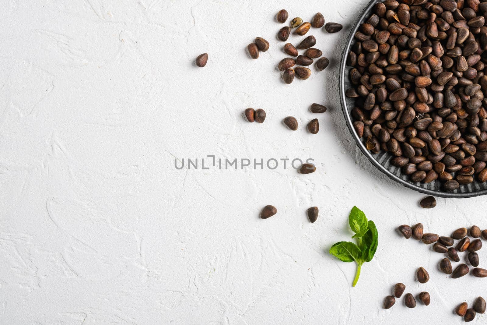Cedar wild organic nut set, on white stone table background, top view flat lay, with copy space for text