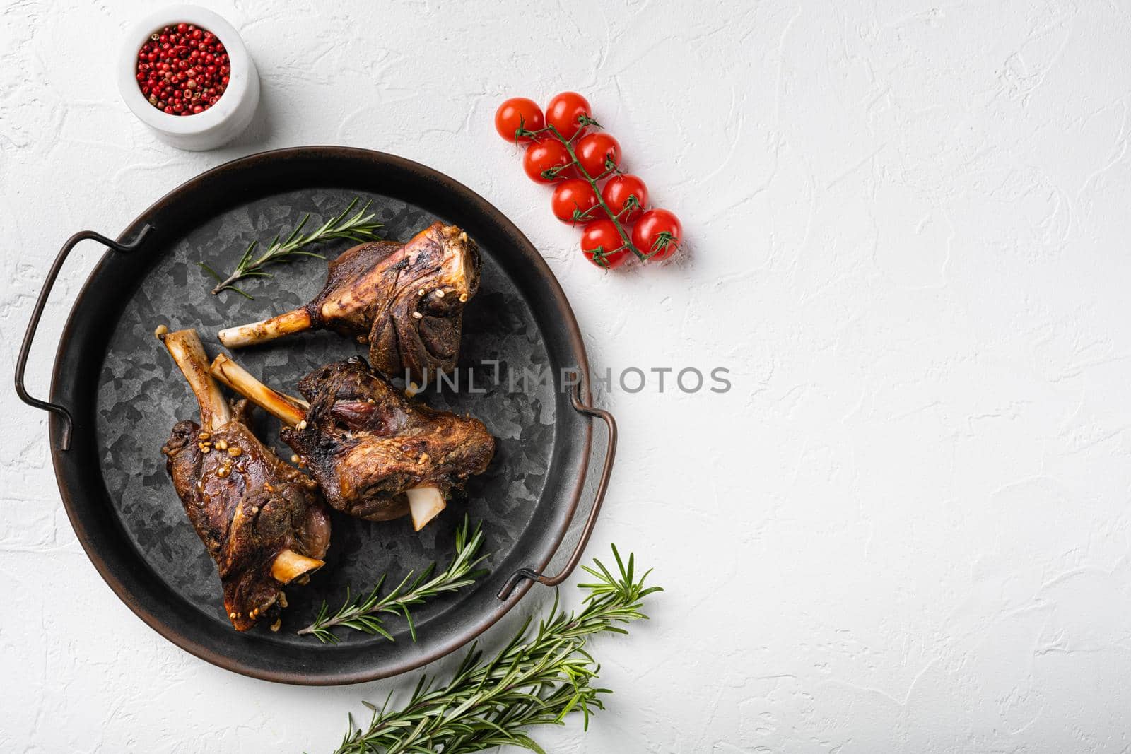 Slow roasted lamb dish meat set, on white stone table background, top view flat lay, with copy space for text