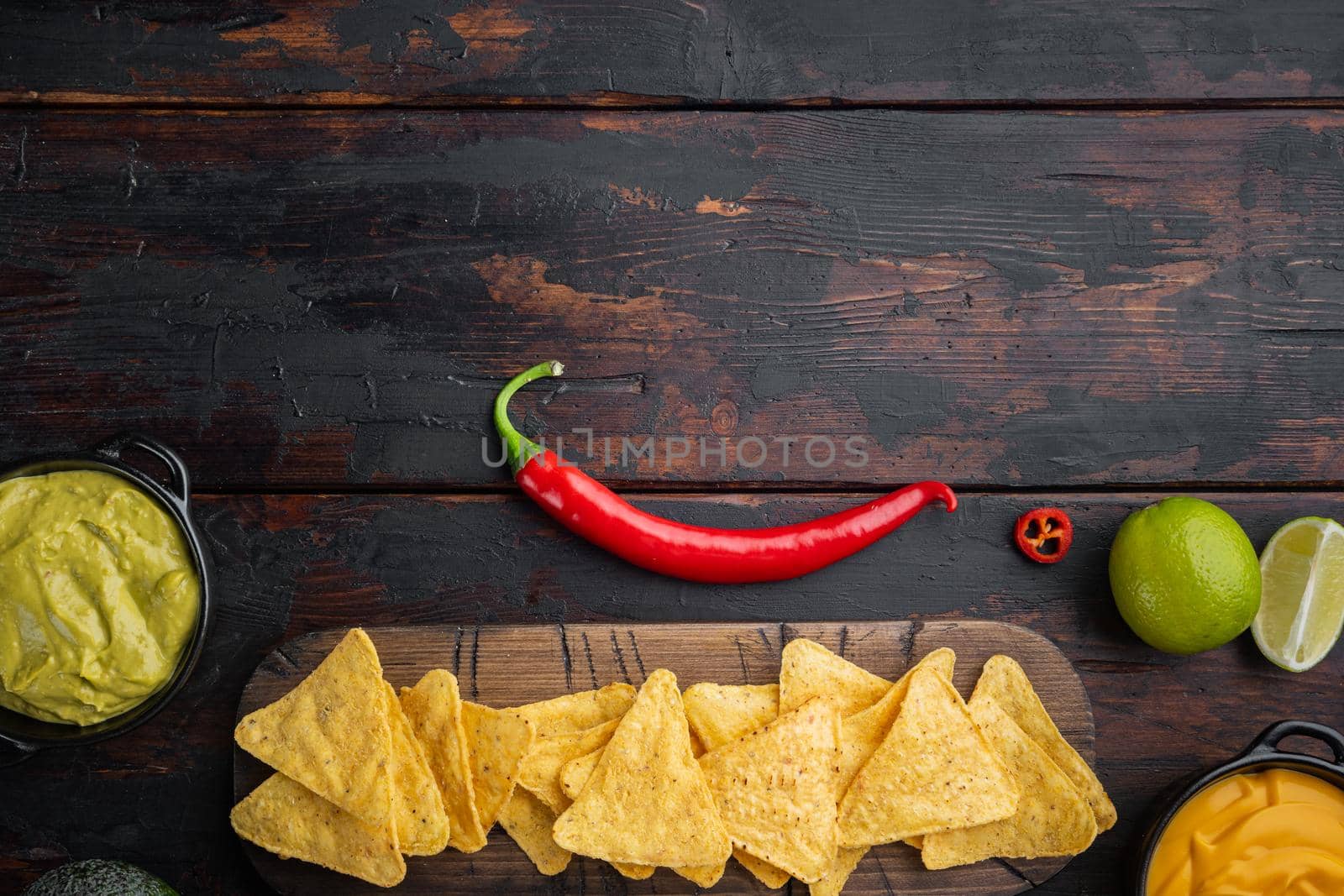 Different dips and sauces for nacho, on old wooden table, top view or flat lay with copy space for text