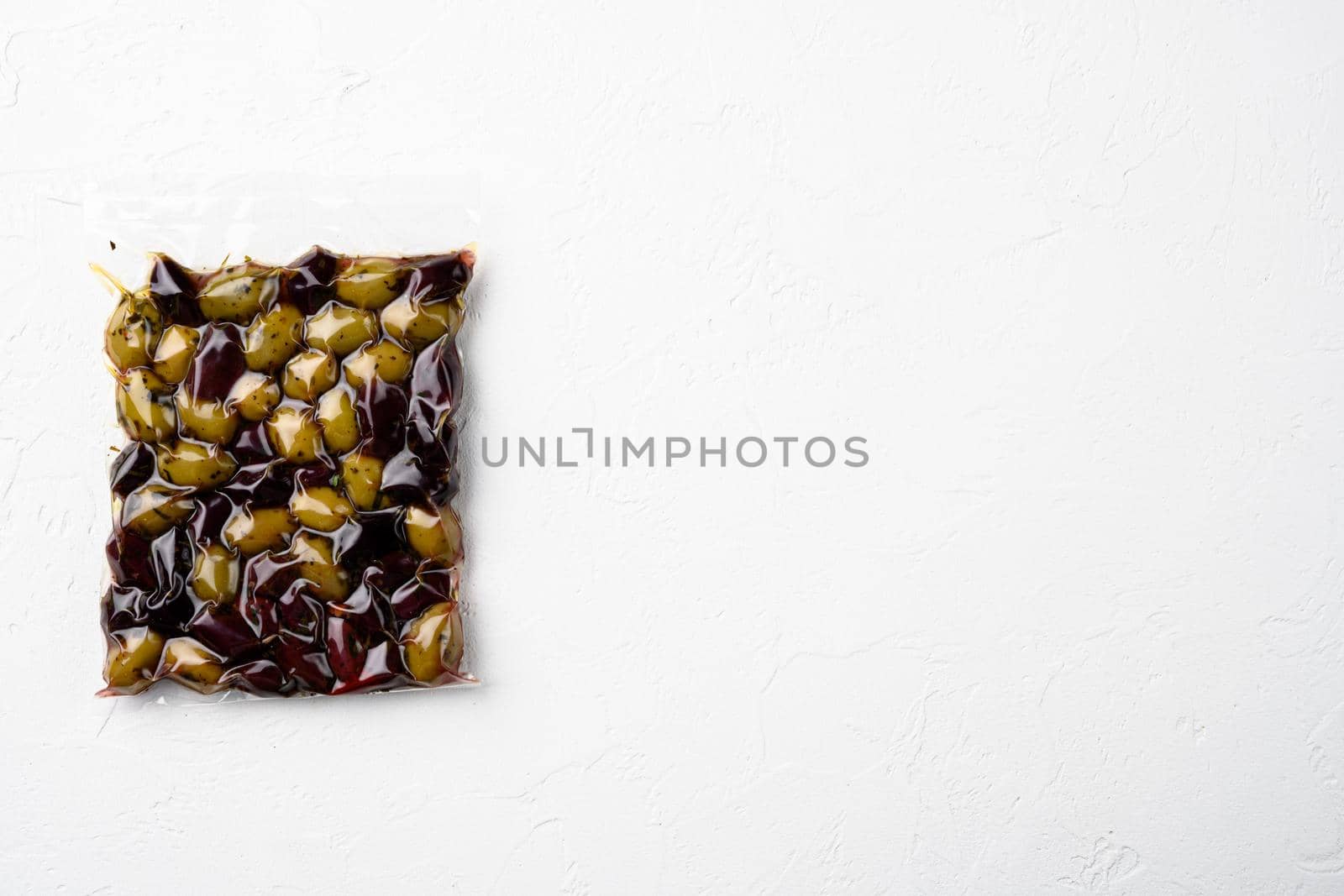 Organic olives vacuum pack set, on white stone table background, top view flat lay, with copy space for text
