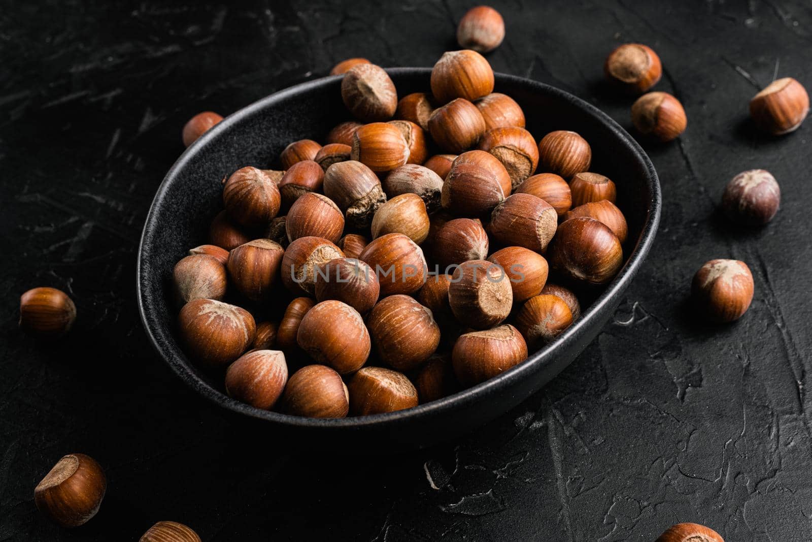 Organic Hazelnut whole nuts set, on black dark stone table background
