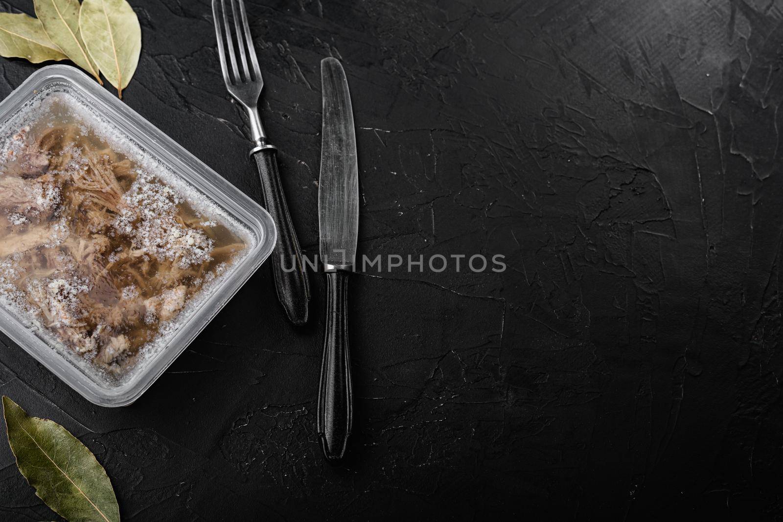 Jellied meat set, on black dark stone table background, top view flat lay, with copy space for text