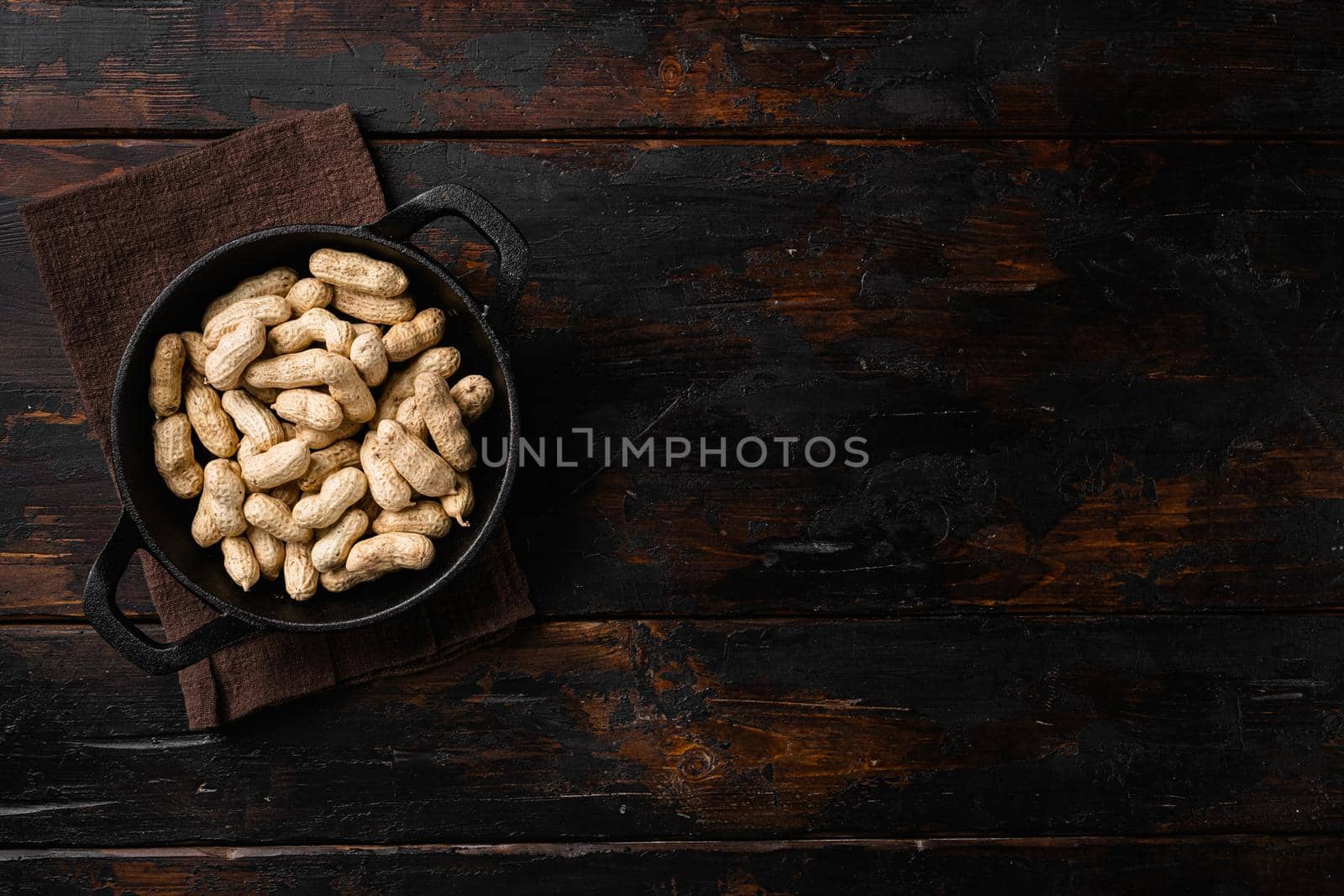 Dried peanuts. Tasty groundnuts set, on old dark wooden table background, top view flat lay, with copy space for text