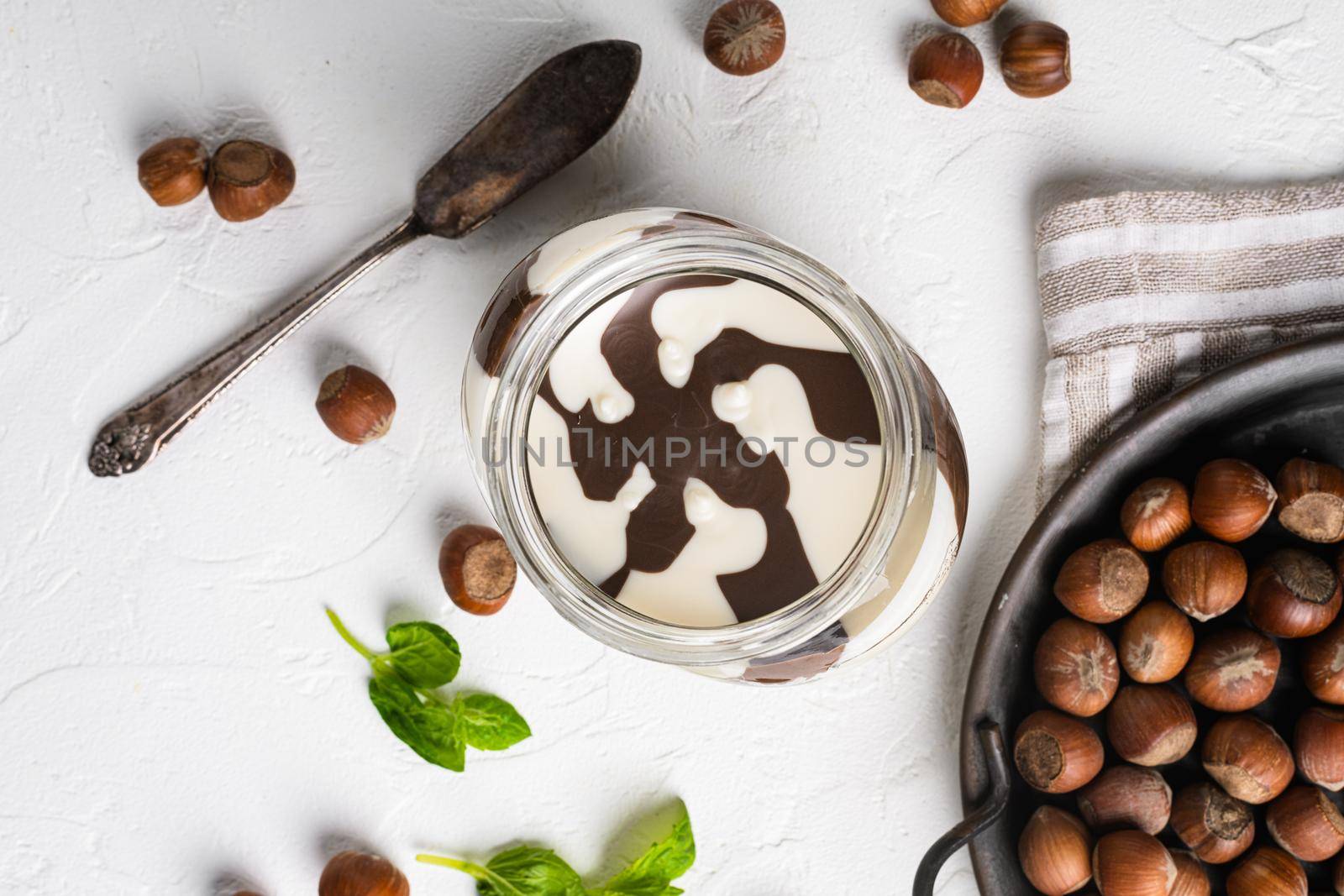 Chocolate spread jar set, on white stone table background, top view flat lay