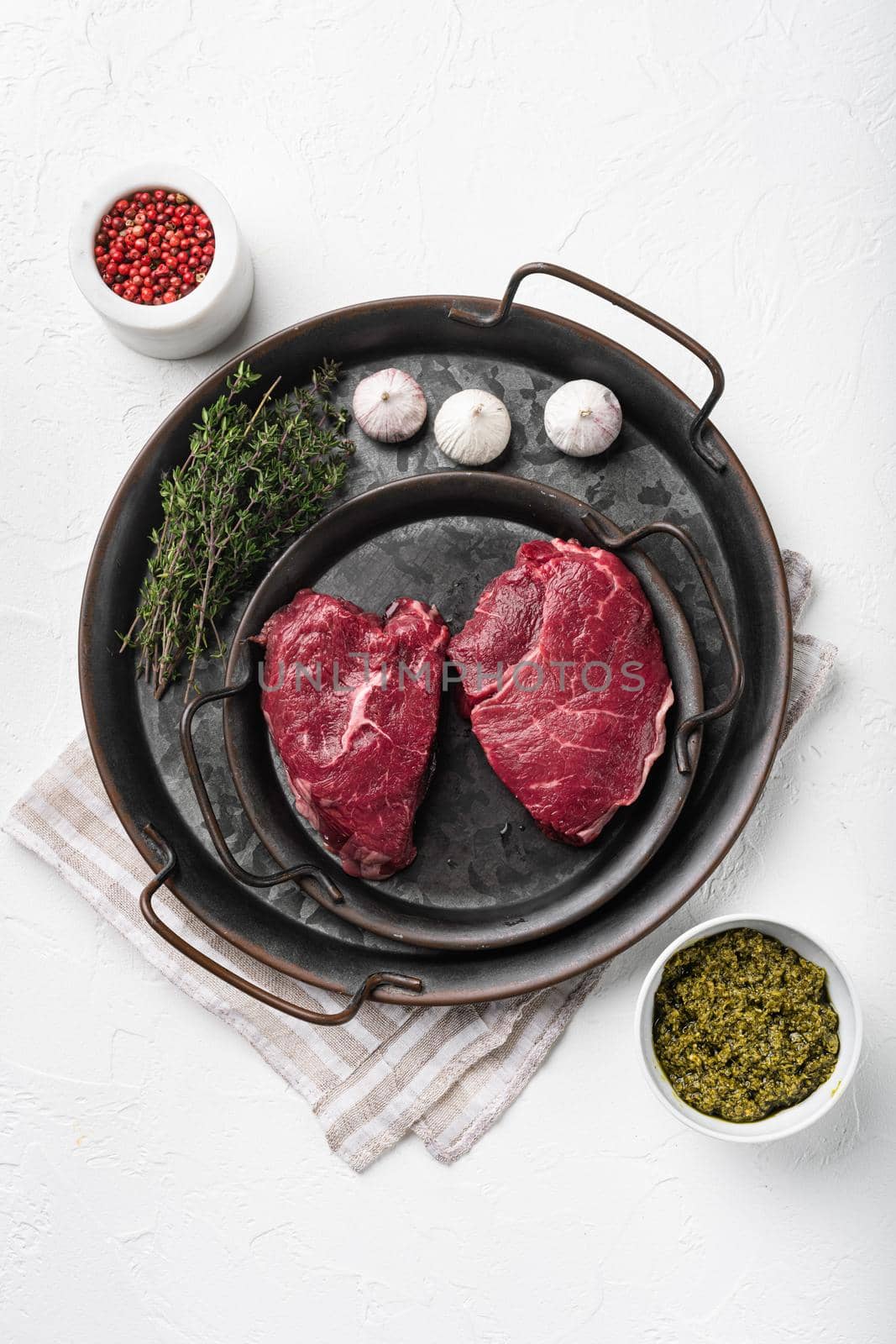 Beef rump meat steak set, on white stone table background, top view flat lay, with copy space for text