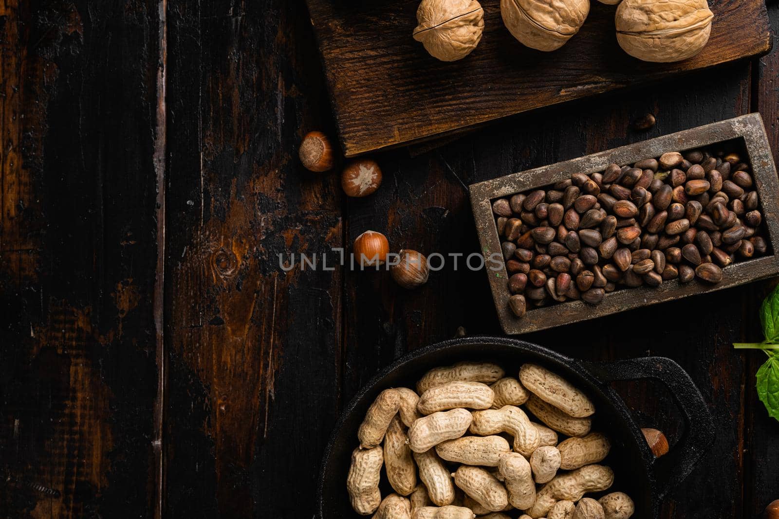 Pine nuts set, on old dark wooden table background, top view flat lay, with copy space for text