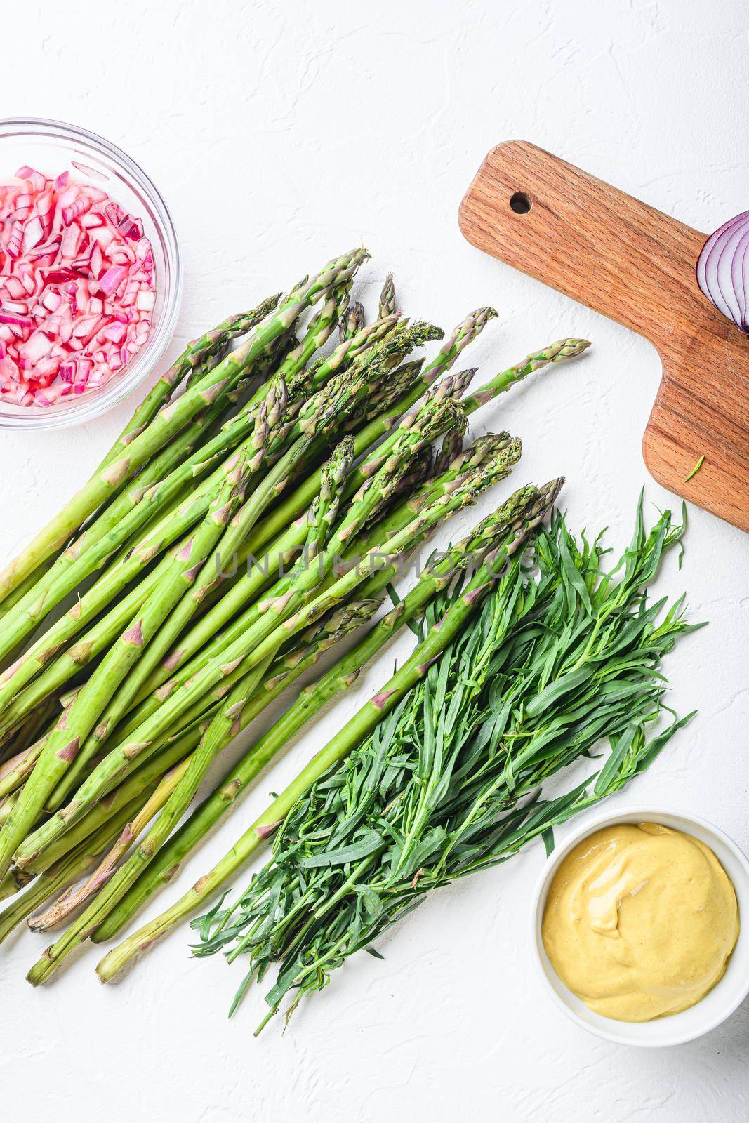 Raw asparagus eggs and french dressing ingredients with dijon mustard, onion chopped in red vinegar taragon on white textured background, top view. by Ilianesolenyi