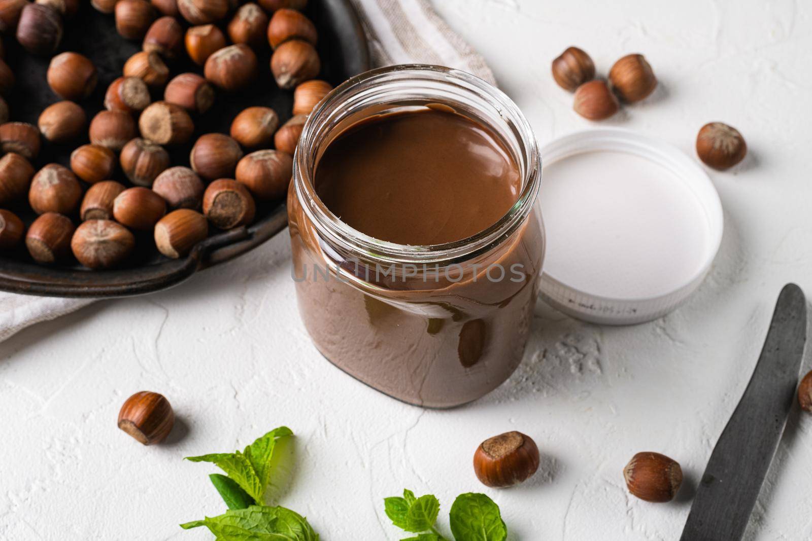 Chocolate Hazelnut Spread set, on white stone table background