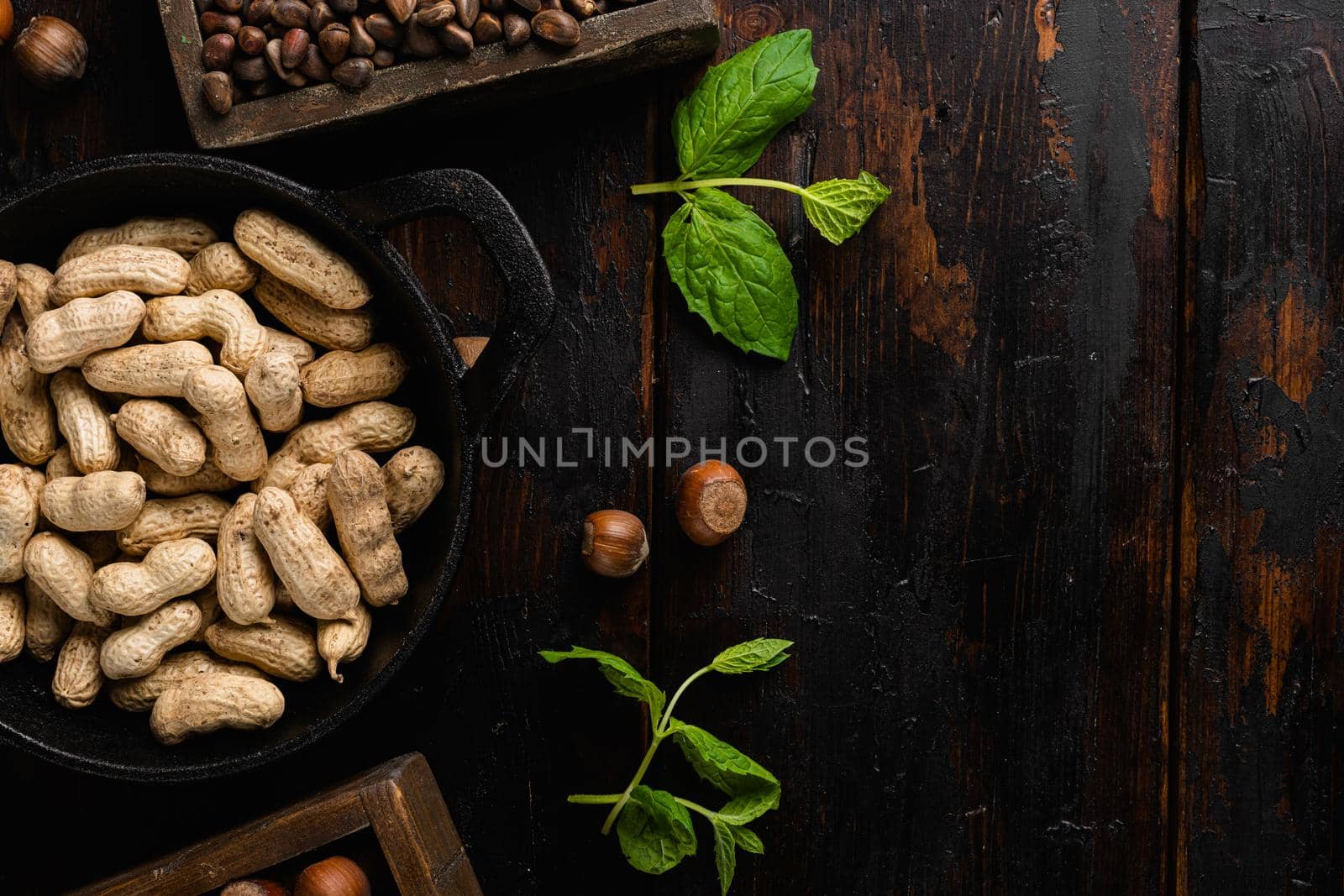 Peanut in a shell, on old dark wooden table background, top view flat lay, with copy space for text by Ilianesolenyi