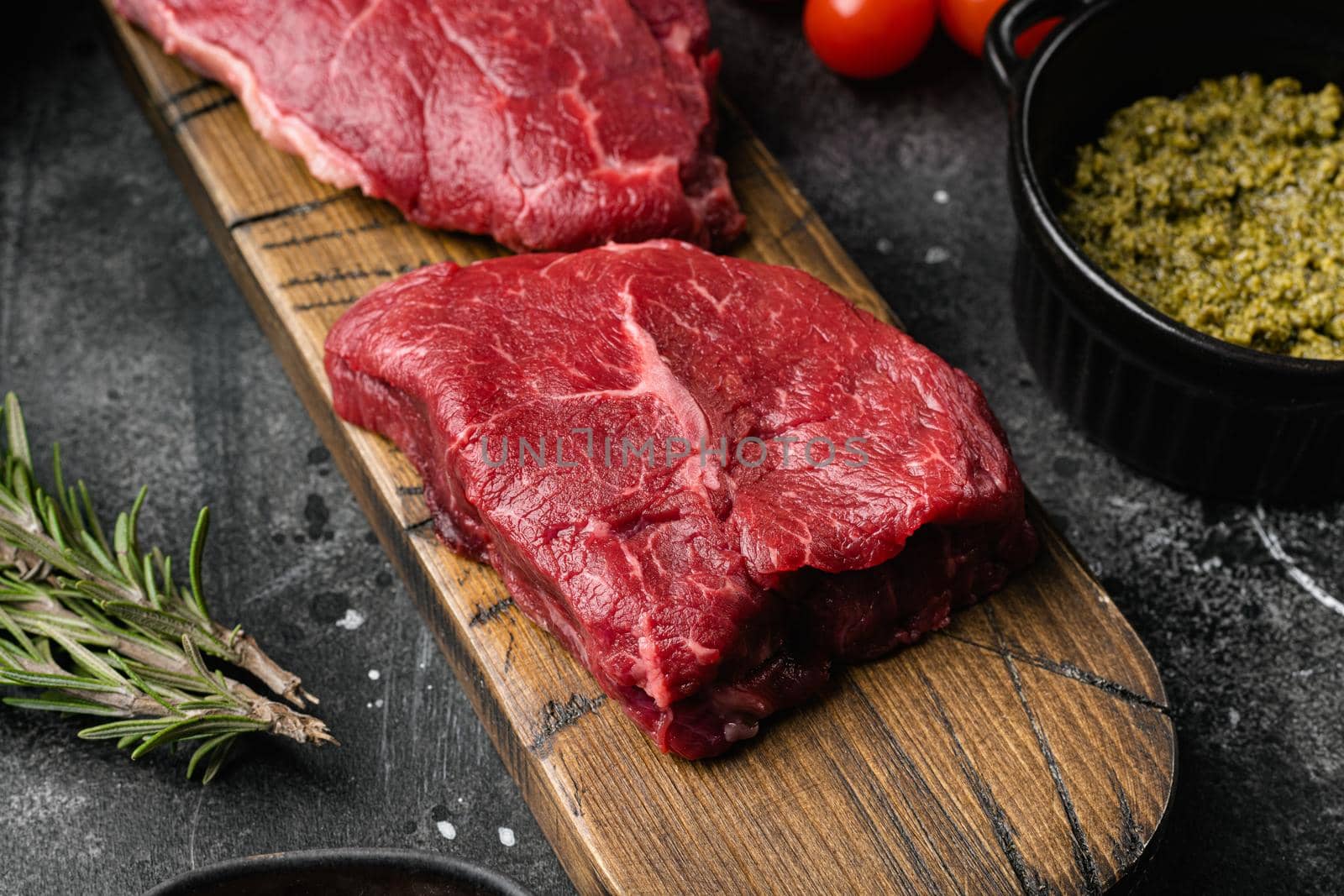 Fresh raw Beef meat Rump Steak, on black dark stone table background by Ilianesolenyi