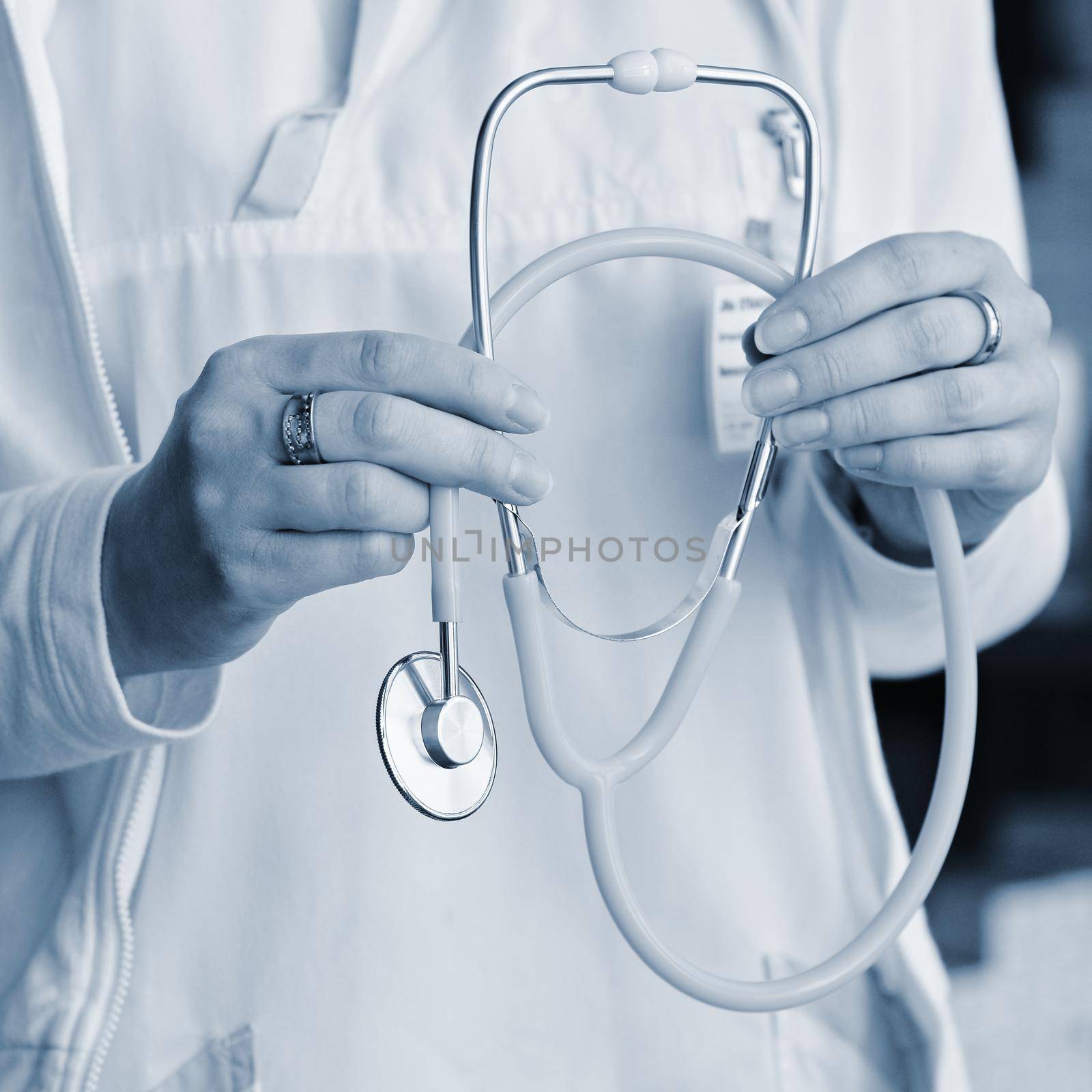 Female doctor holding a stethoscope. Concept for health and medicine. Hospital background. by Montypeter