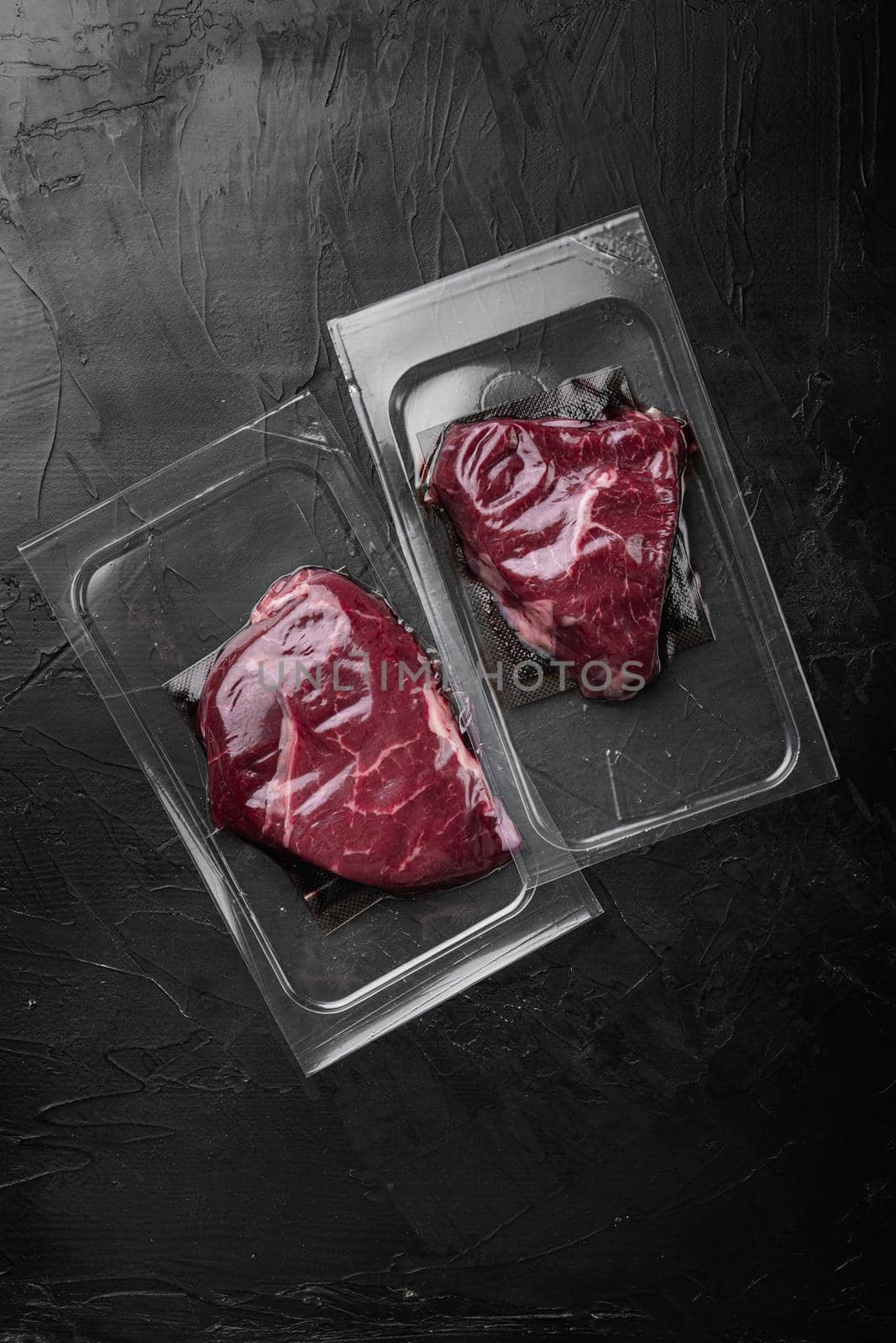 Beef rump steak pack set, on black dark stone table background, top view flat lay, with copy space for text