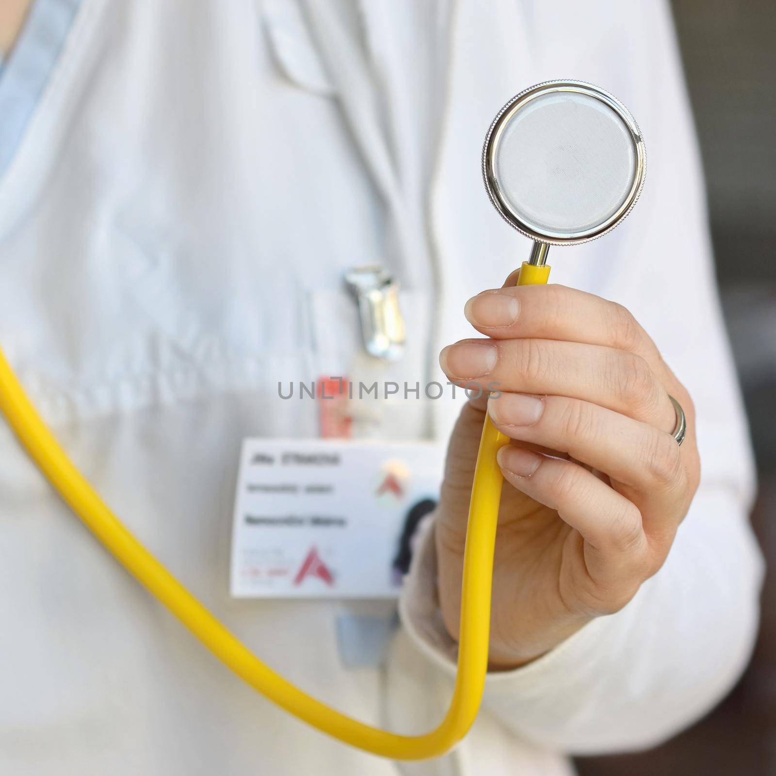 Female doctor holding a stethoscope. Concept for health and medicine. Hospital background. by Montypeter